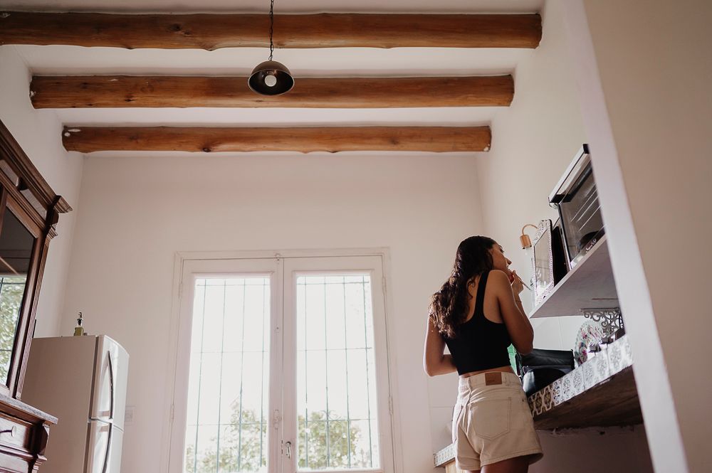 A series of connected images showing a loft-style room interior with exposed wooden beams and white walls. wedding in mendoza