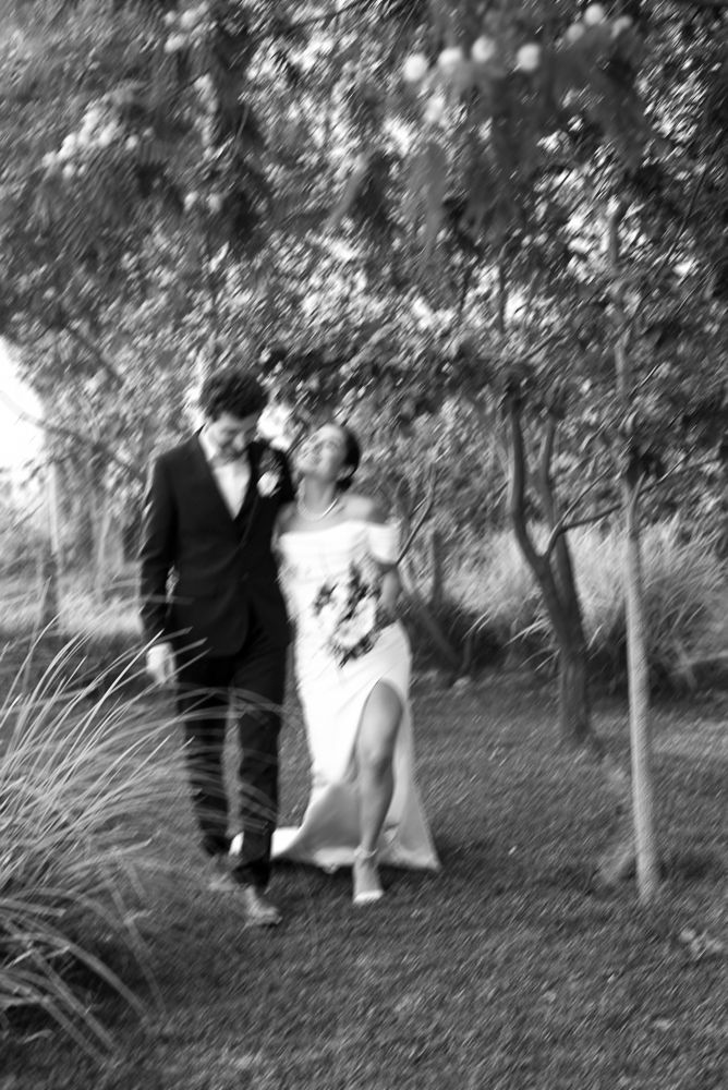 A sequence of black and white photos shows two figures dancing together in a garden setting. wedding in mendoza
