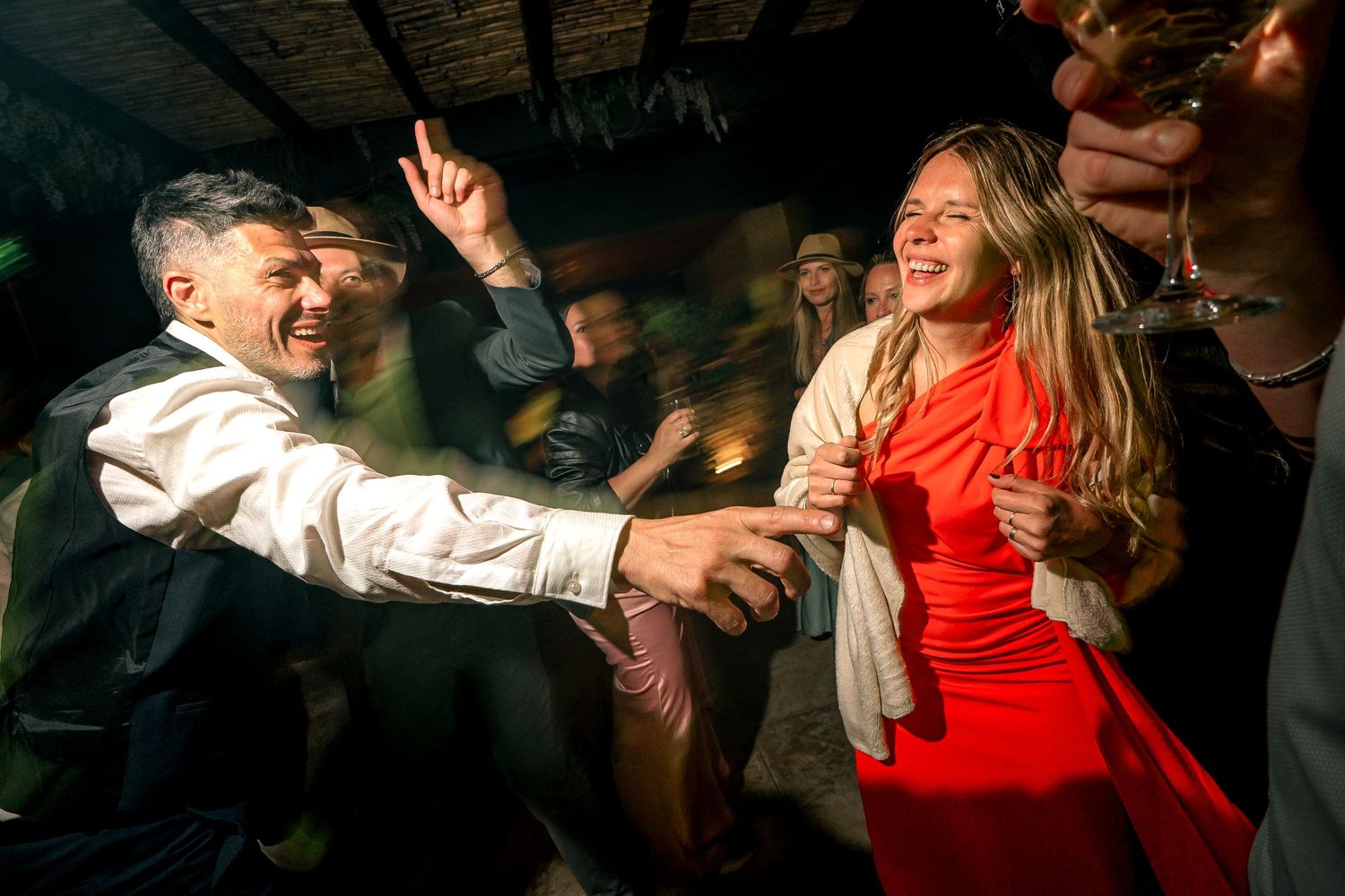 A sequence of dance moves shown in multiple frames capturing dynamic movement and red clothing in dim lighting.