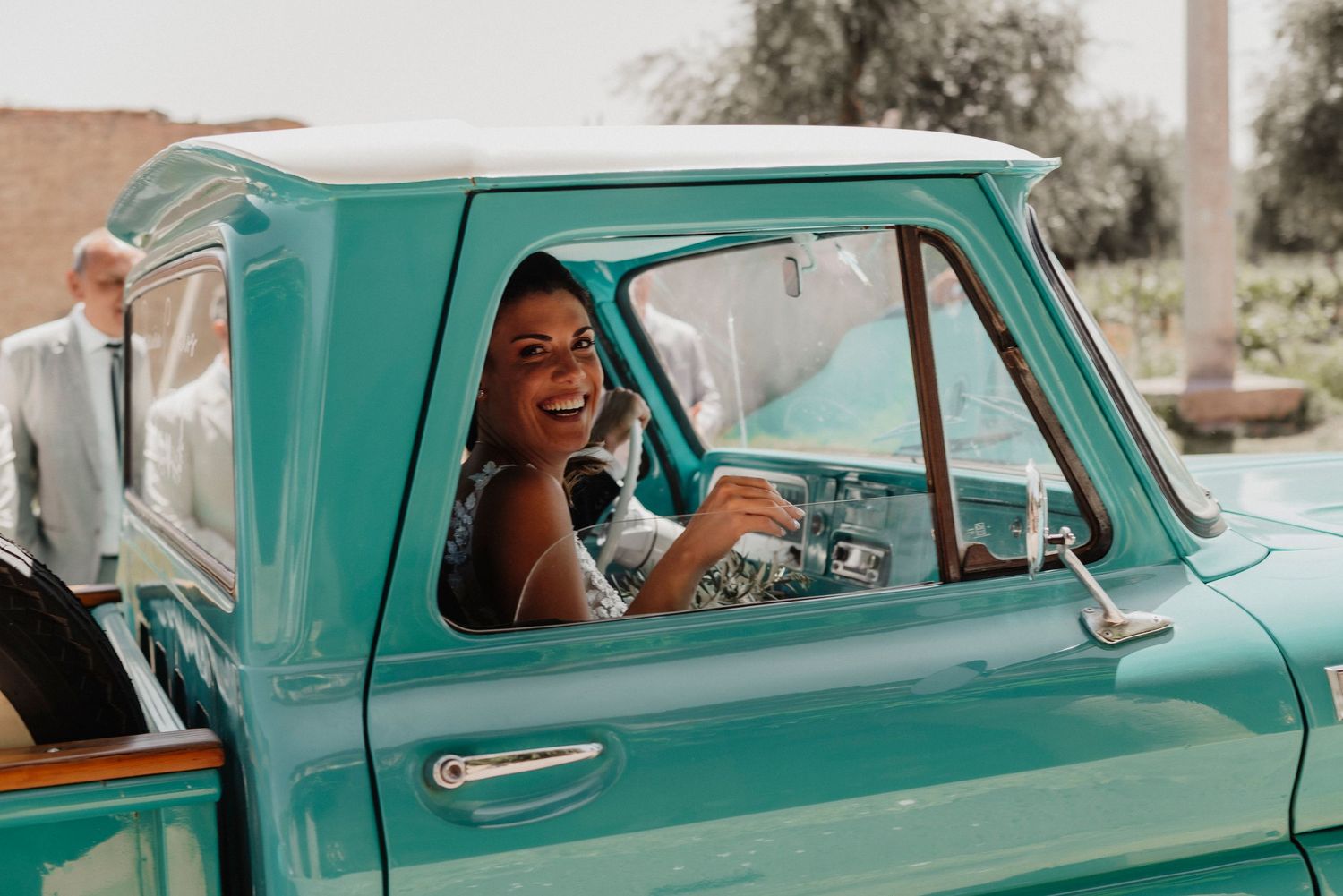 Vintage turquoise classic car photographed from multiple angles with someone sitting in driver's seat.