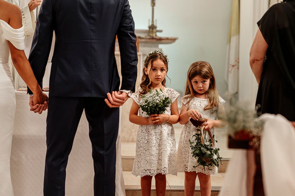 A wedding party stands in a line on a hardwood floor during a formal ceremony. wedding in mendoza