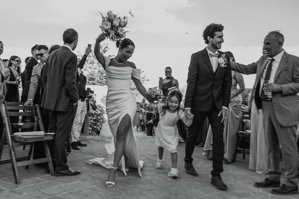 Black and white photo collage showing candid moments from a wedding reception with guests dancing and socializing. wedding in mendoza