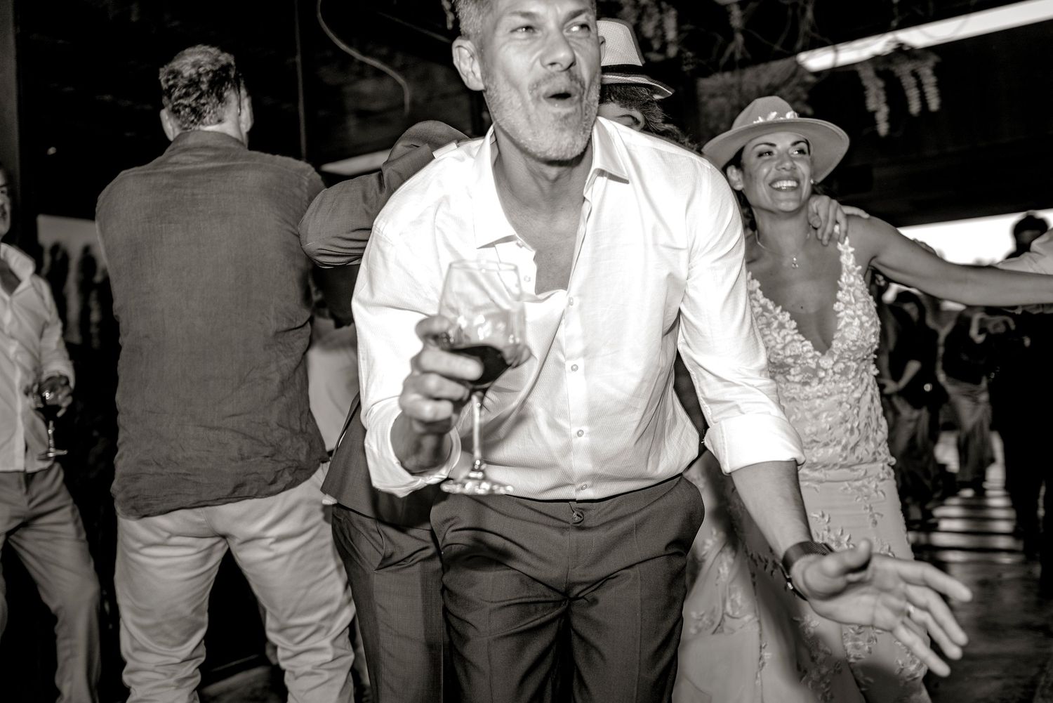 A black and white photo montage showing people dancing and socializing at what appears to be a nightclub or party.