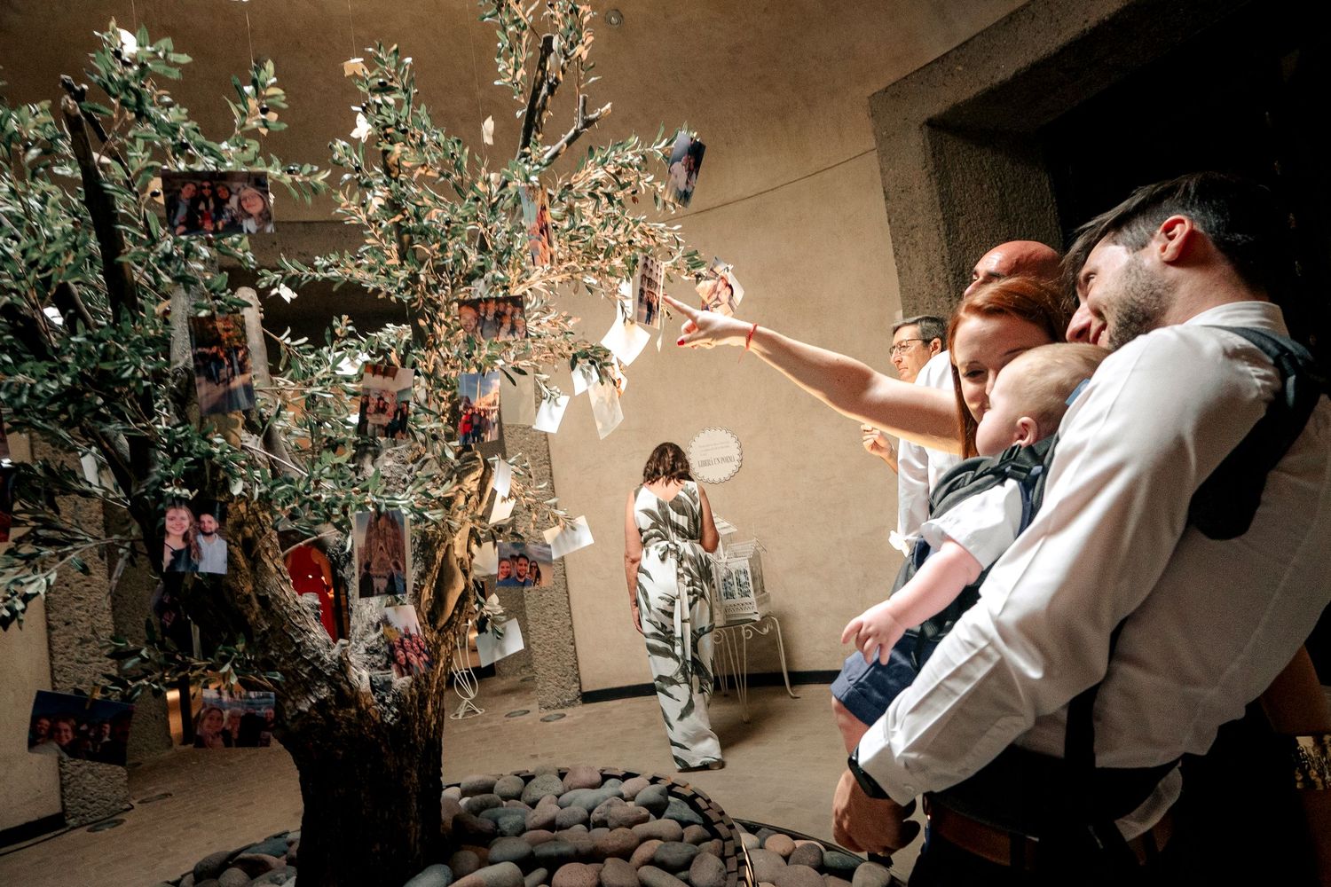 Wedding couple dances under a crystal chandelier during their first dance at an elegant reception venue.