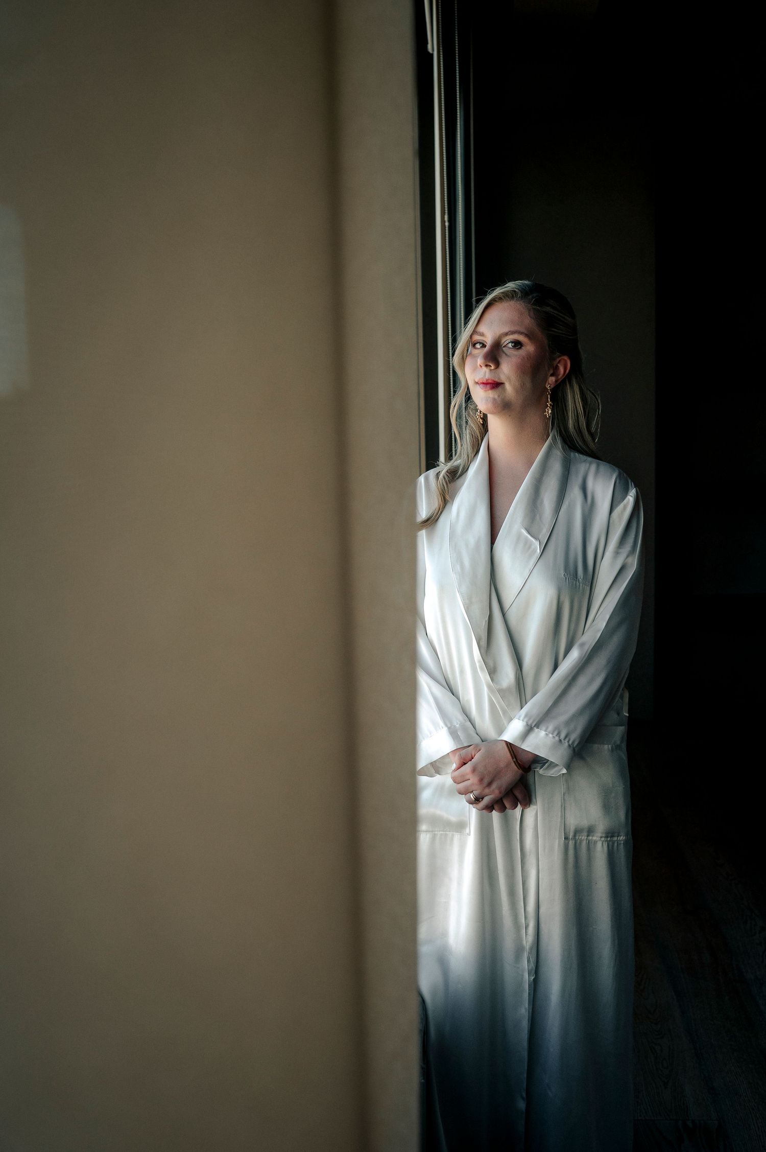 A moody series of portraits showing a figure in a white robe against a dark background in different contemplative poses.