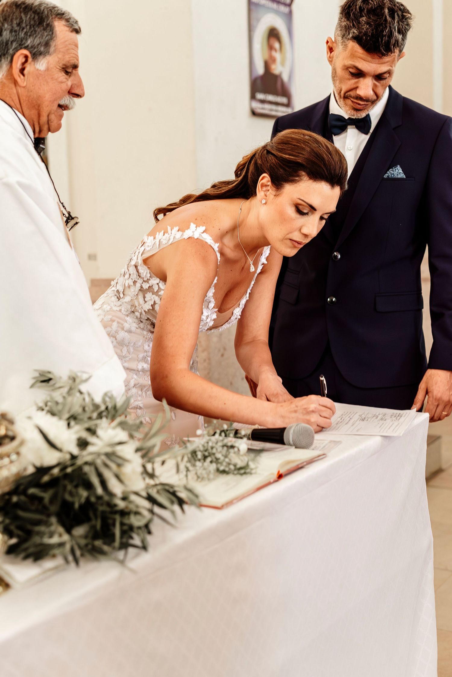 A couple signs their marriage certificate at a wedding ceremony, captured in a series of progressive shots.