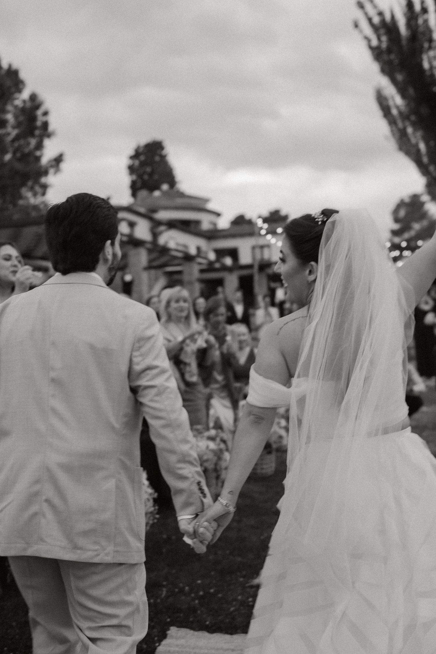 Black and white photo sequence shows a bride and groom dancing at their outdoor wedding reception.