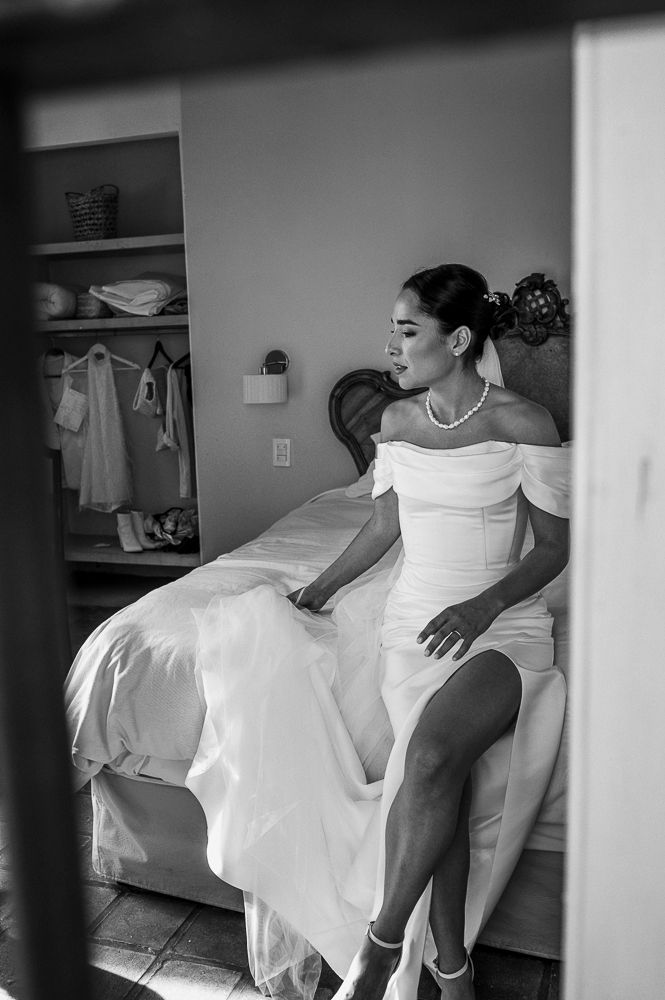 A black and white photo sequence showing a person in a white wedding dress twirling and dancing in a room. wedding in mendoza