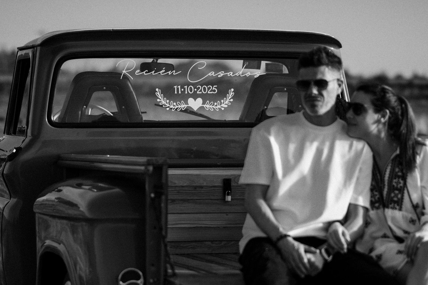 Black and white image of a crowded subway car interior with passengers sitting and standing during a commute.