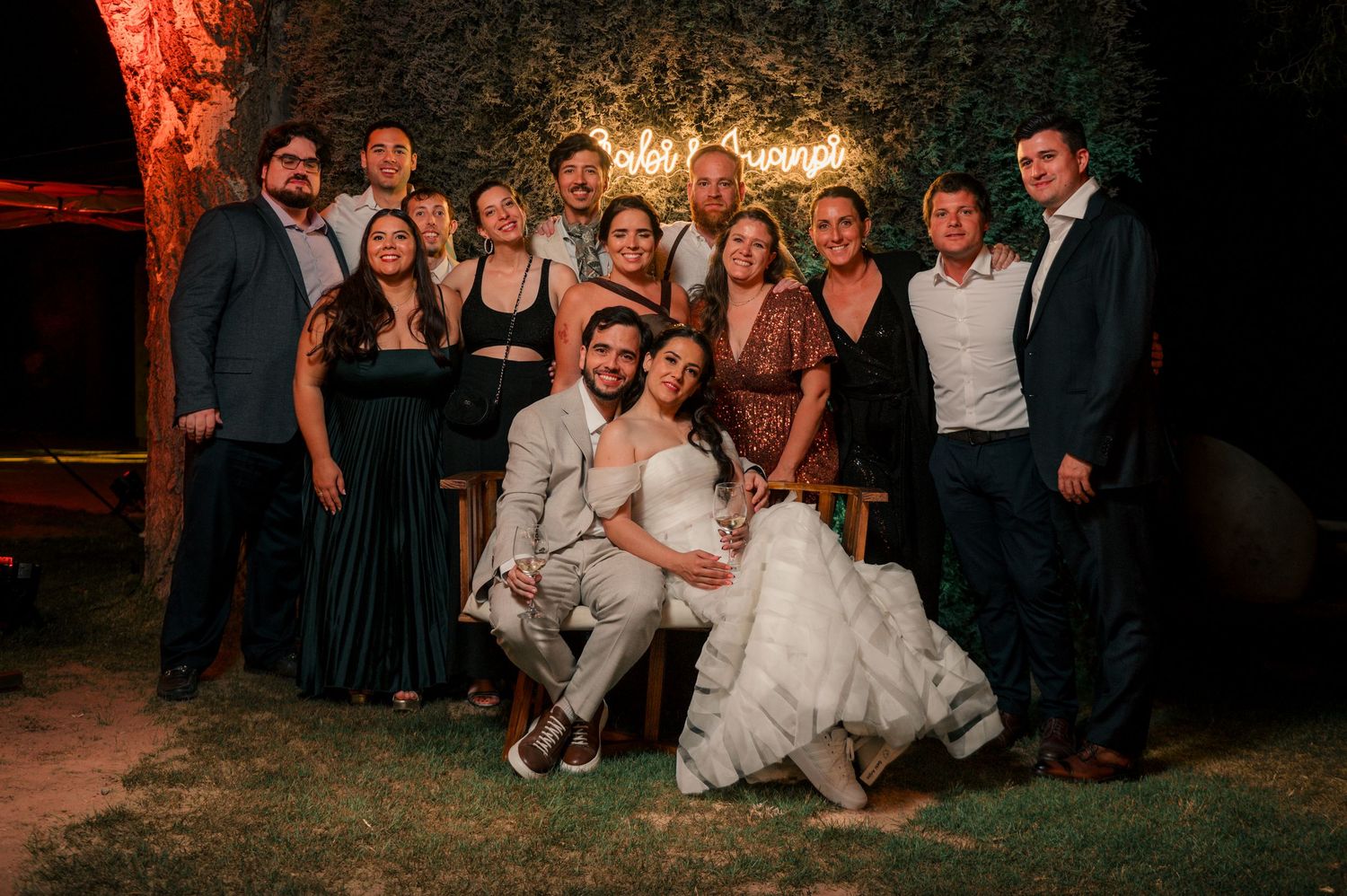 A series of candid wedding party photos taken outdoors at dusk with warm lighting and festive atmosphere.