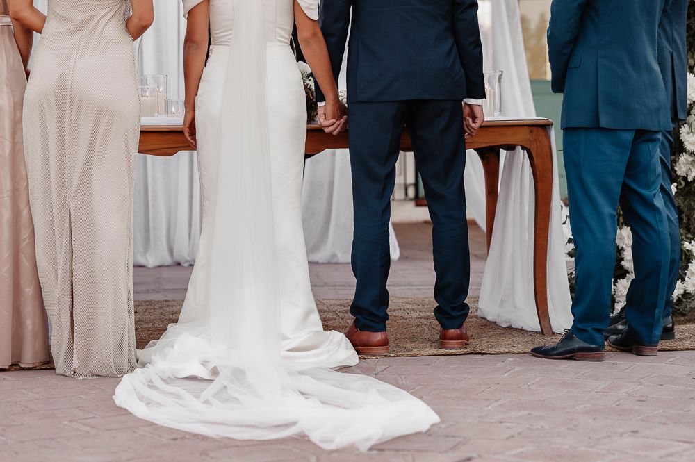 Bride and groom share a joyful moment wiping away tears during their outdoor wedding celebration. wedding in mendoza