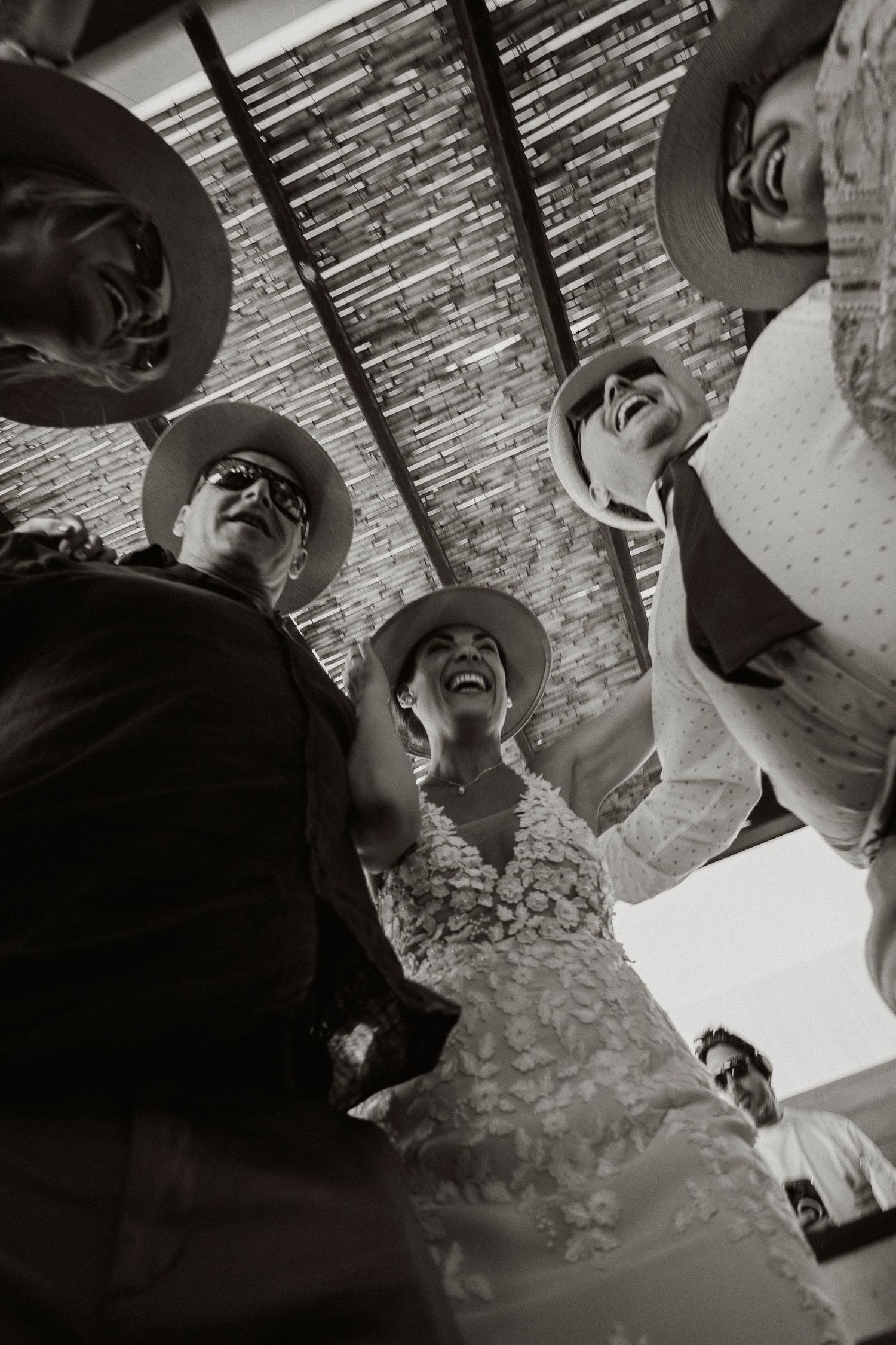 A black and white photo sequence showing people laughing and having fun in a candid moment.