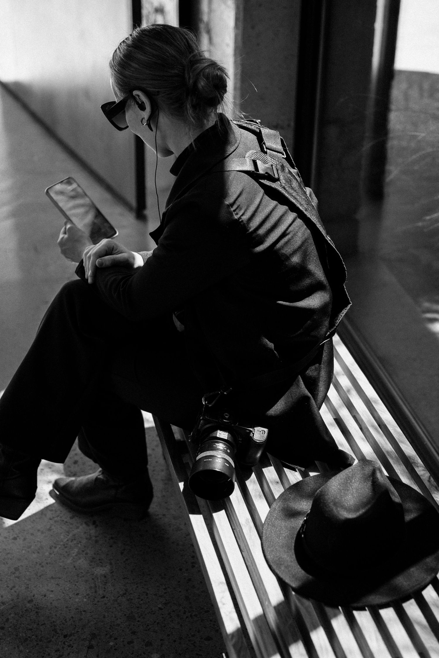 Black and white artistic photo series showing a person sitting on a bench in dramatic lighting and shadows.