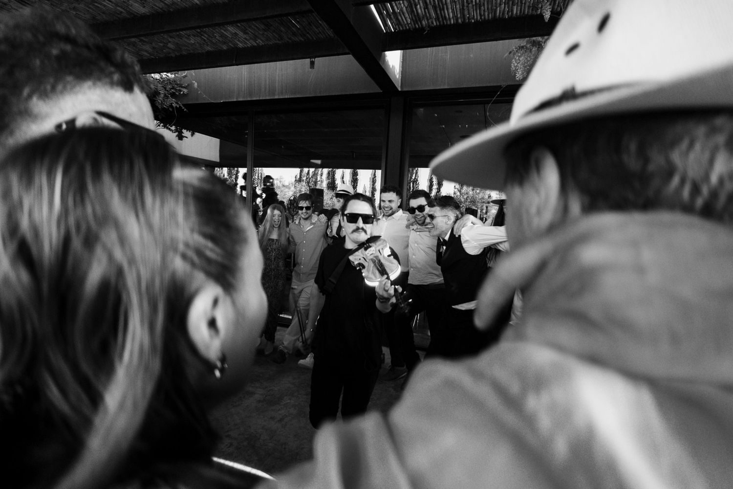 Black and white crowd scene at what appears to be a busy transit station or platform.