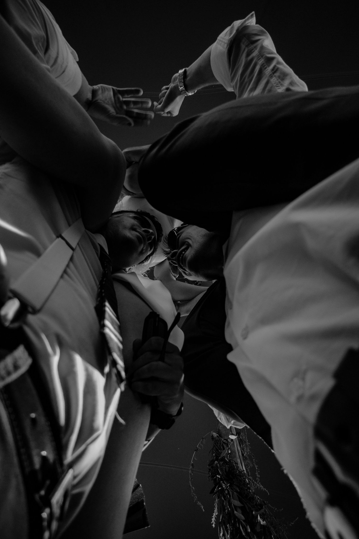 A series of black and white abstract photographs showing flowing fabric and shadows in dramatic lighting.