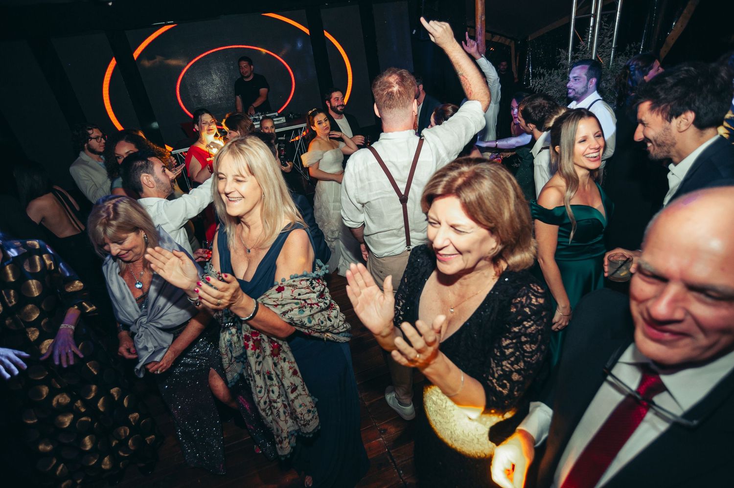 People dancing and celebrating at a lively nightclub party with energetic crowd on the dance floor.
