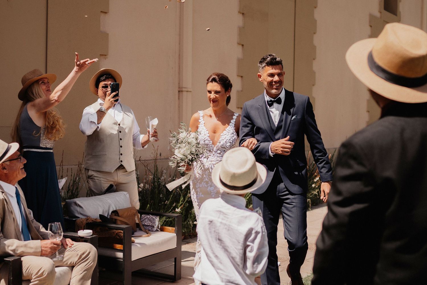 A wedding celebration with guests dancing and mingling at an elegant indoor reception venue.