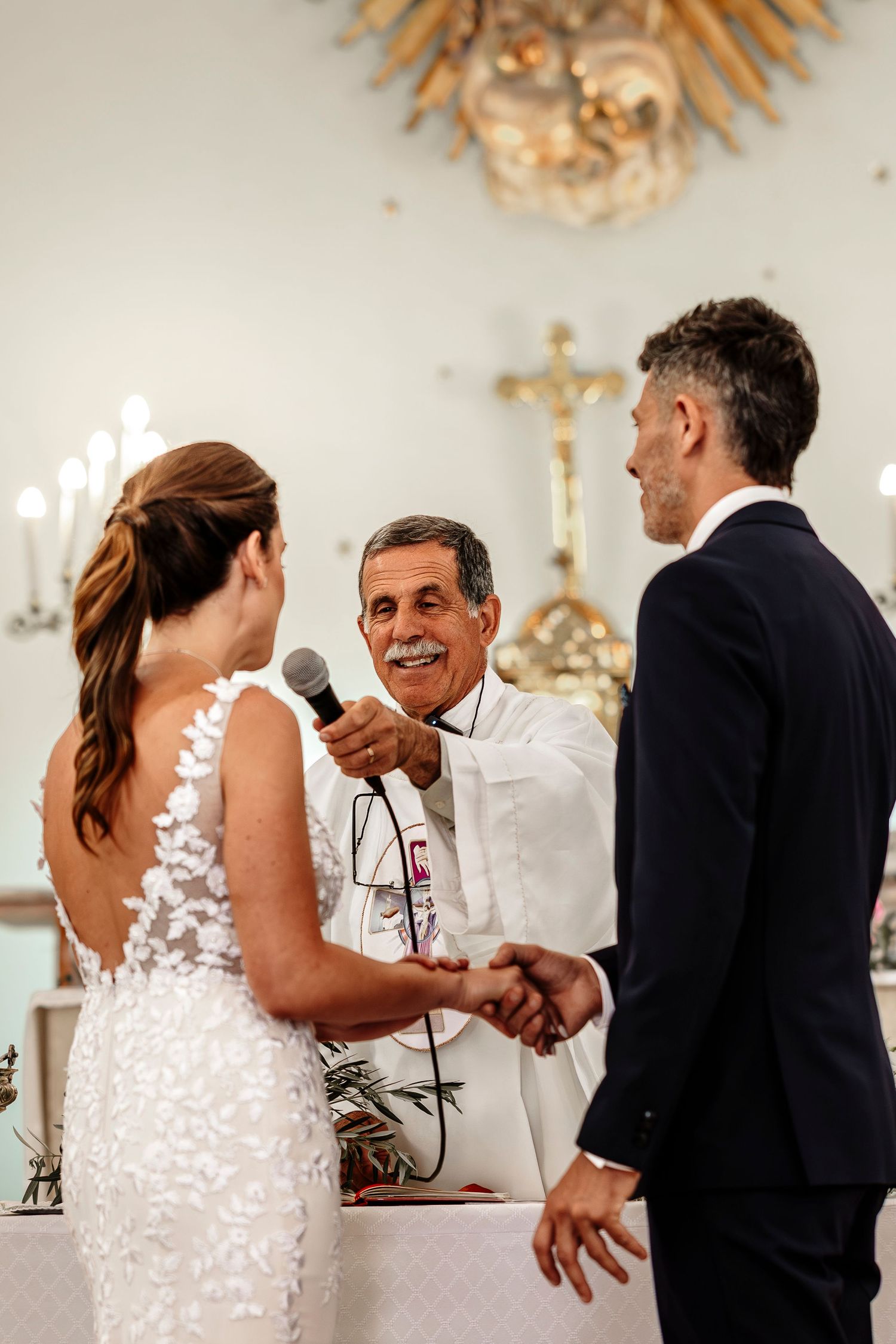 A sequence of wedding ceremony moments showing a couple exchanging rings in an elegant white room with ornate decor.