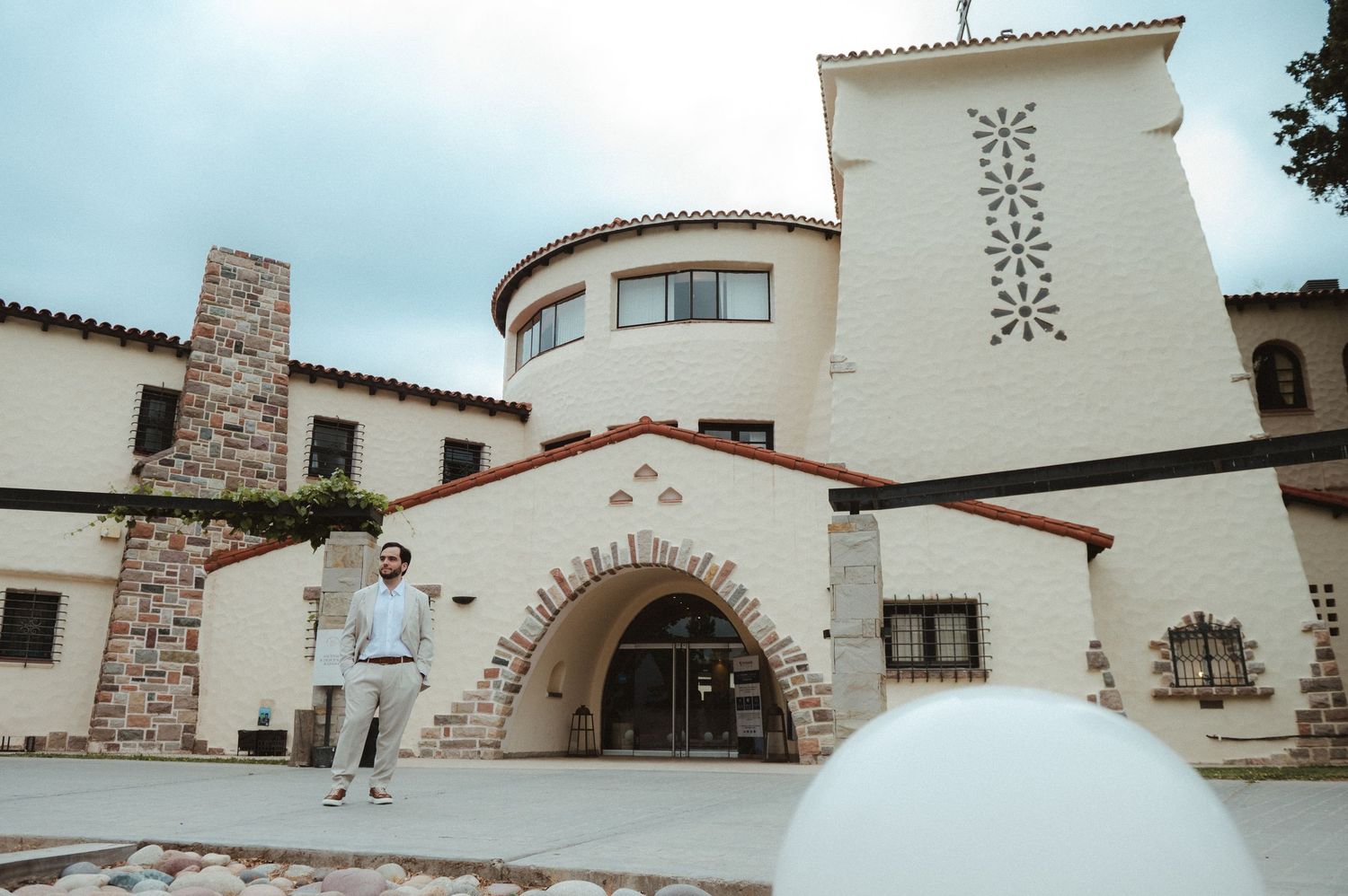 White stucco Spanish colonial style buildings with terracotta roofs and stone accents create an architectural panorama.