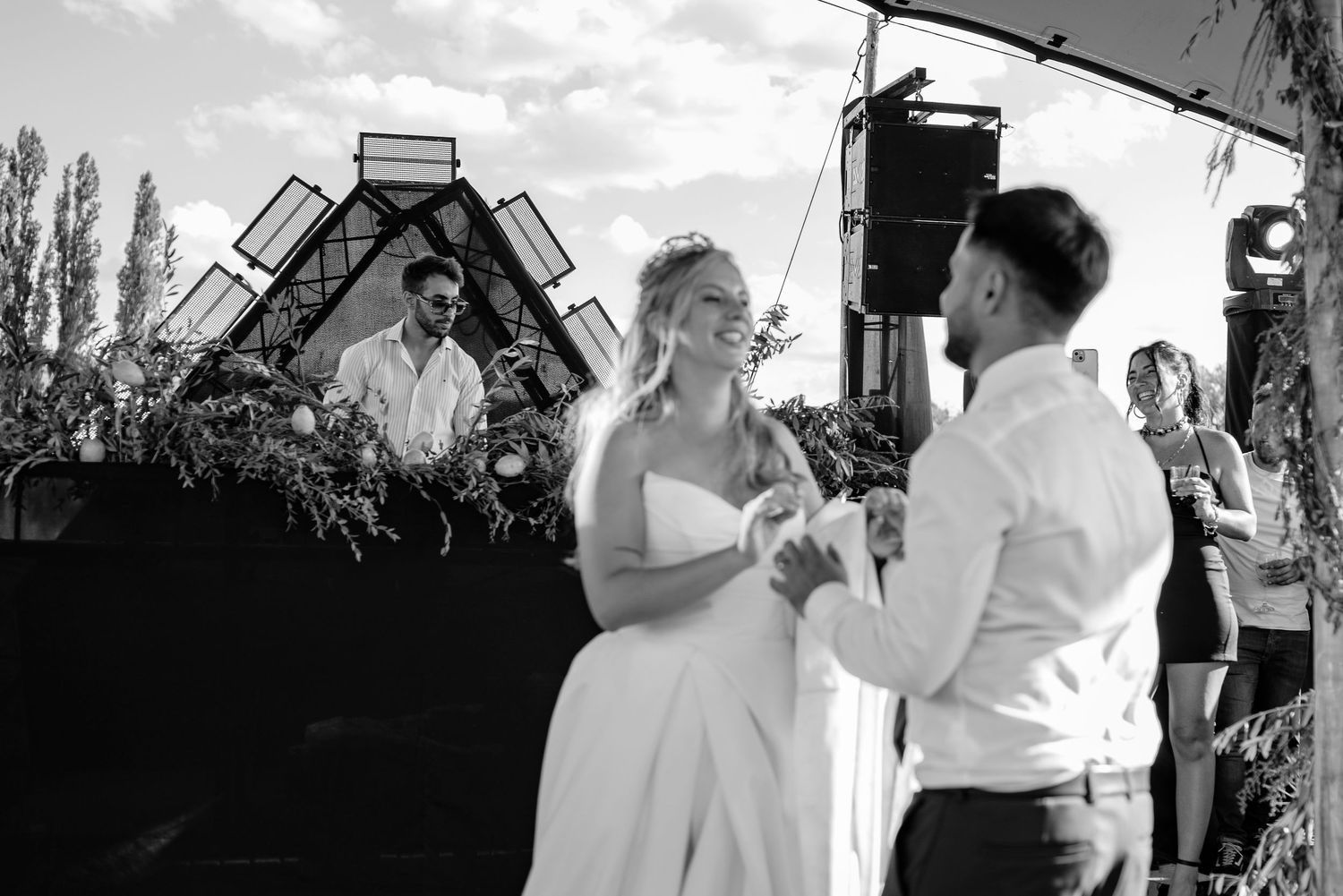 Black and white photos of couples dancing together at an outdoor event with trees in the background.