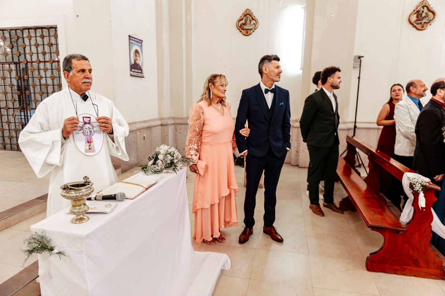 A series of wedding photos showing guests and wedding party members in a white-walled venue with peach accents.