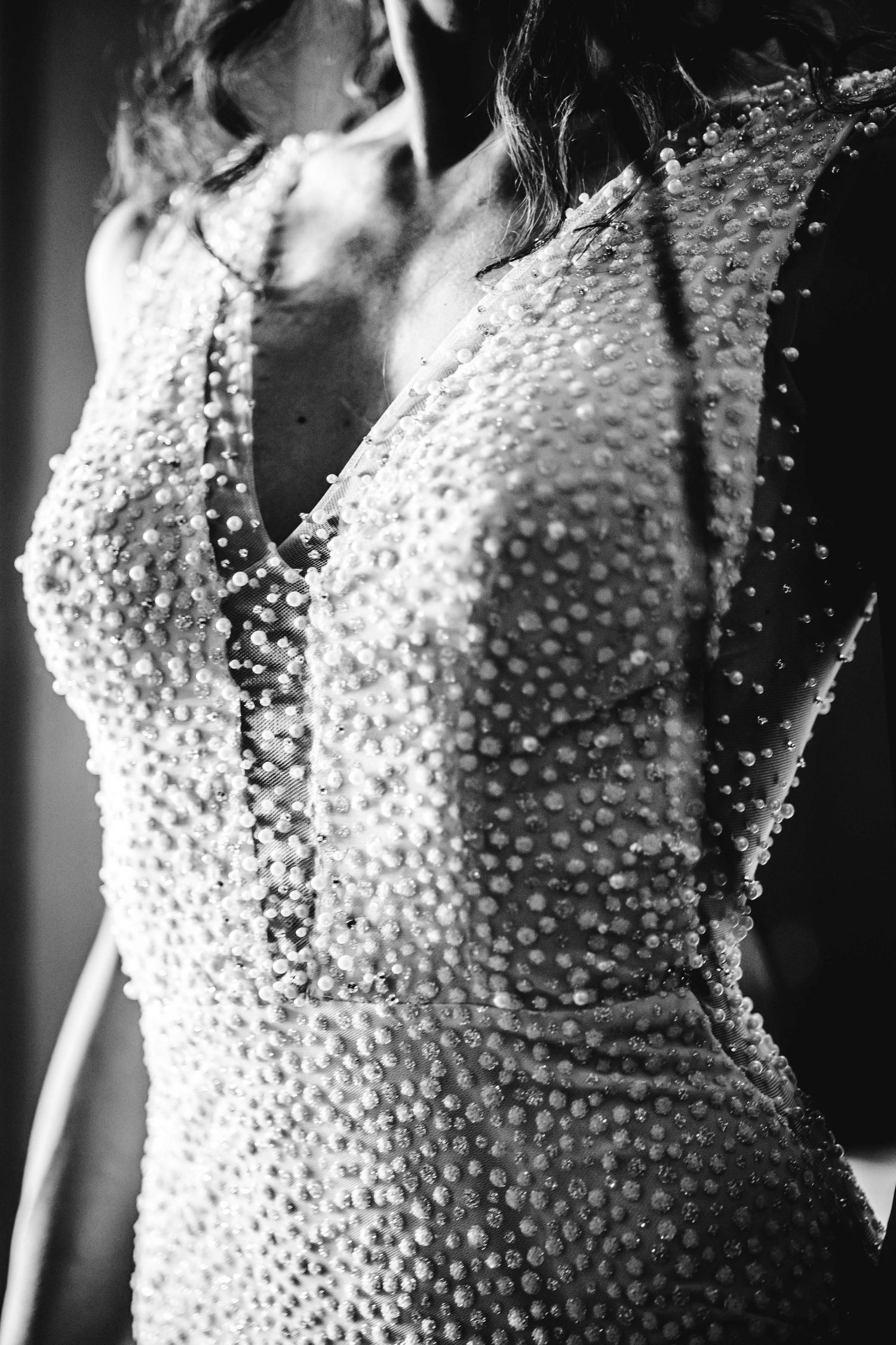 Black and white detail shot of a beaded wedding dress bodice.
