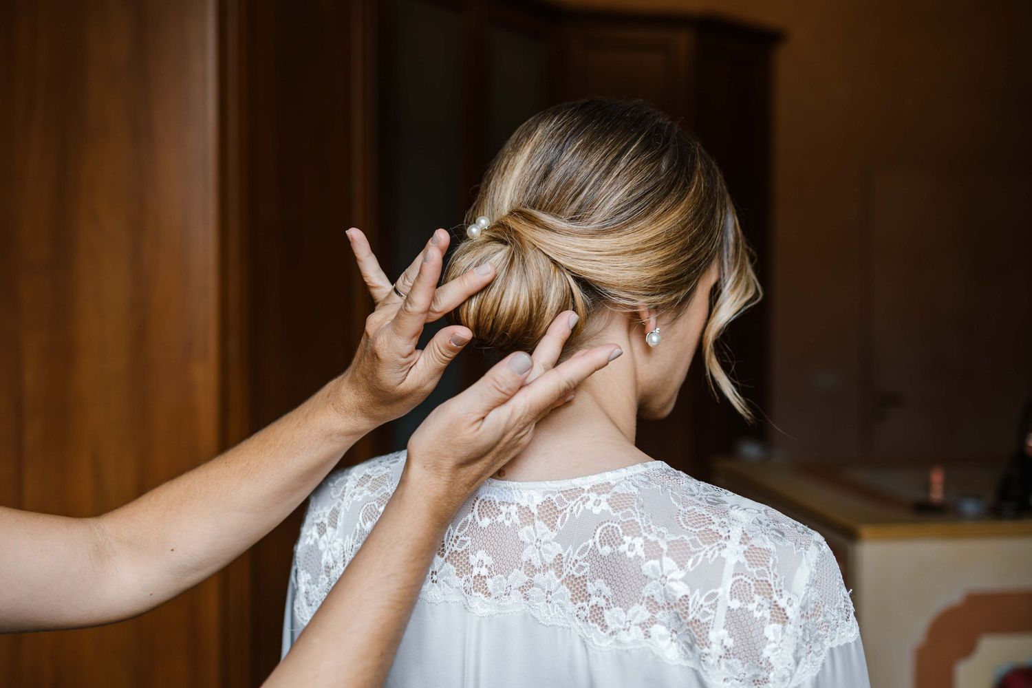 Hair styling moment captured during wedding preparations.