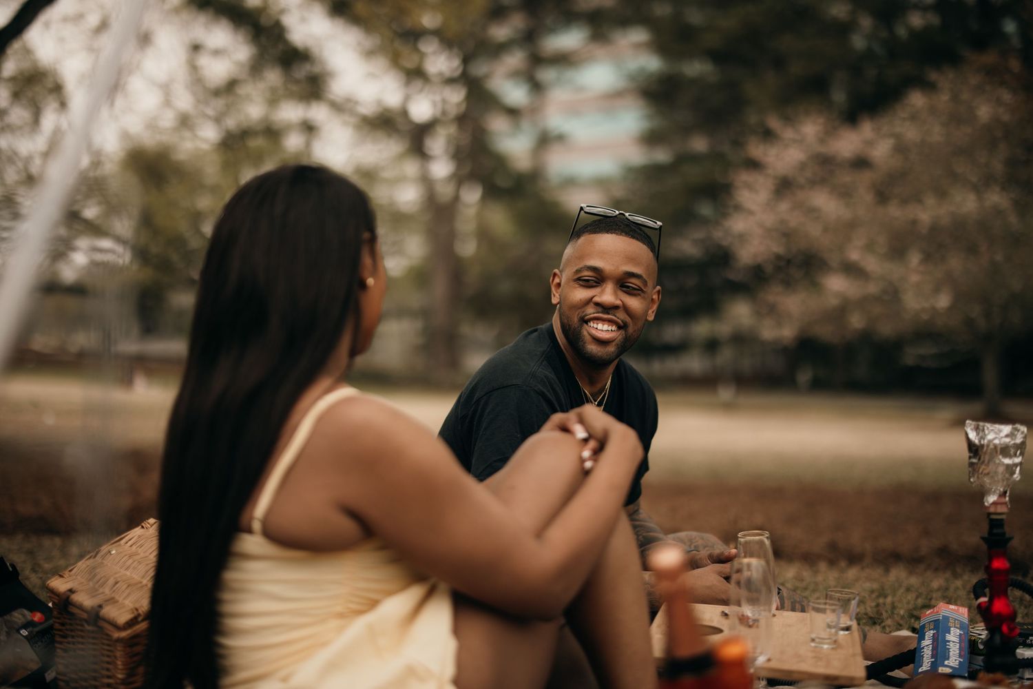 black couple enjoying romantic picnic in Atlanta, Georgia. black couple taking cinematic photos during romantic picnic. romantic picnic idea