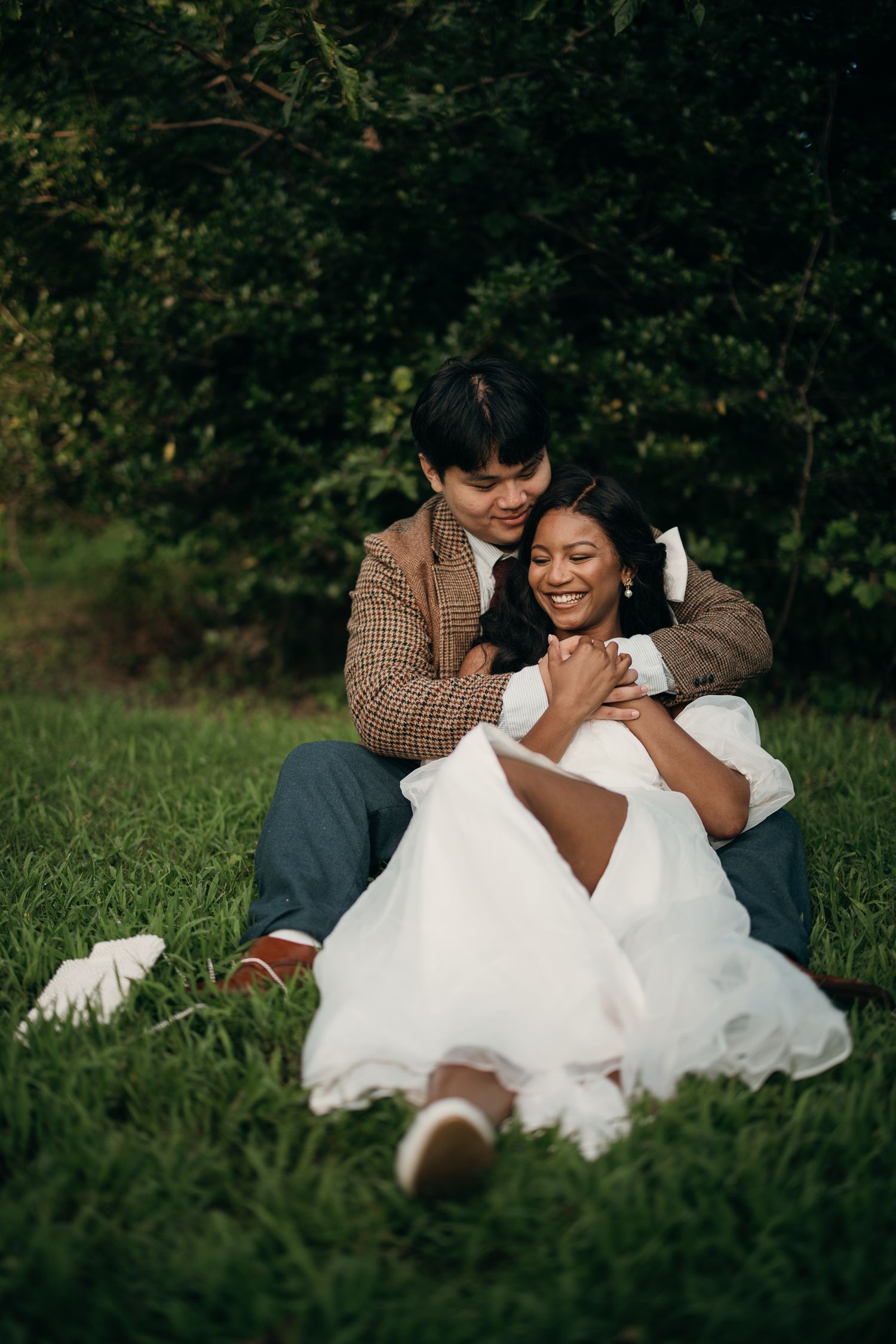 Candid elopement photography of a couple laying in the grass at Piedmont Park, Atlanta.
