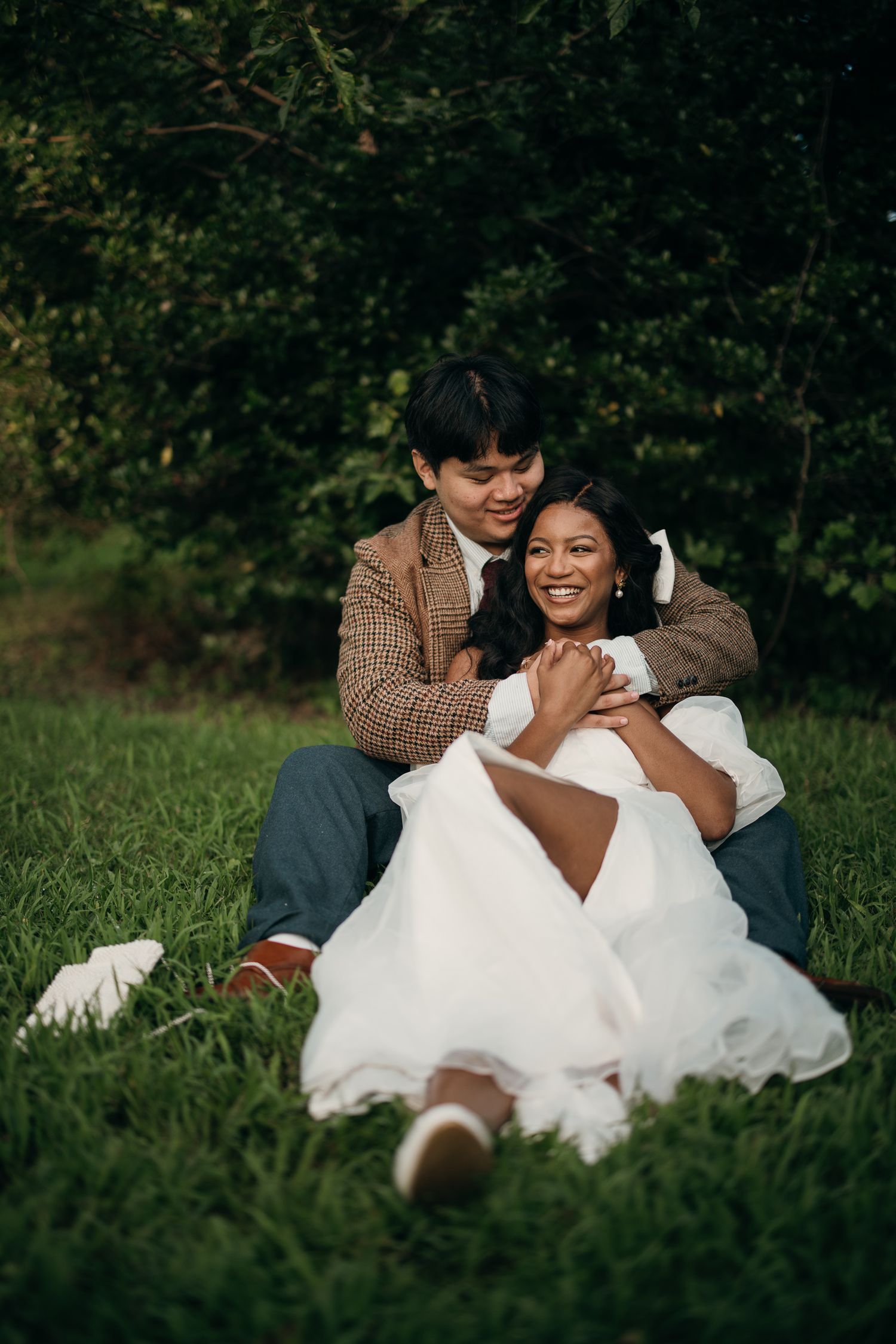 Candid elopement photography of a couple laying in the grass at Piedmont Park, Atlanta.