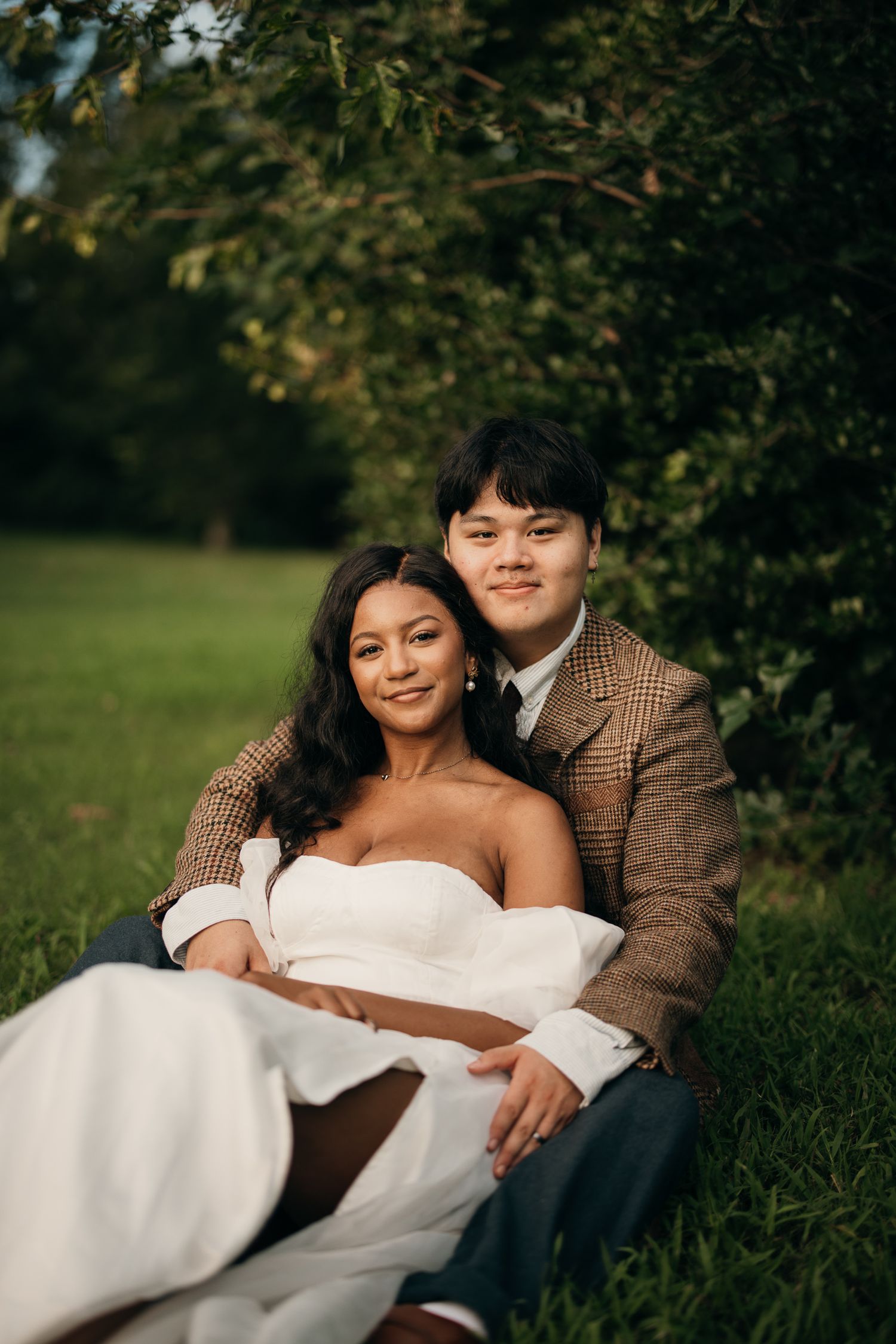 Candid elopement photography of a couple laying in the grass at Piedmont Park, Atlanta.