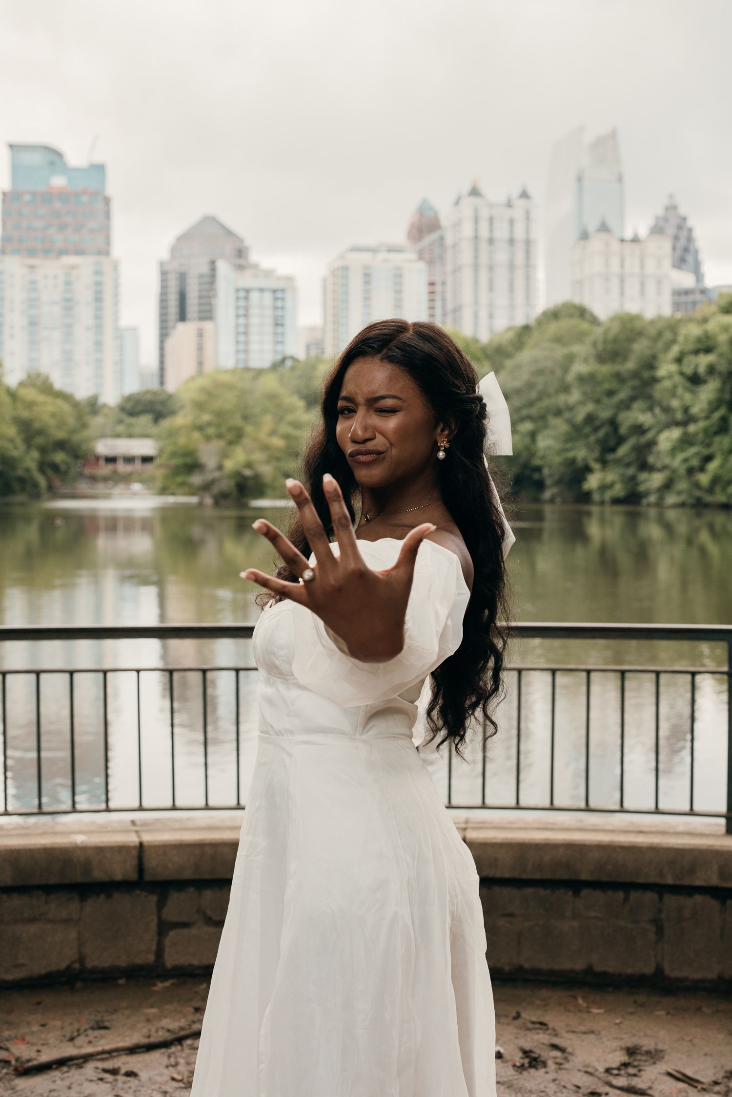 Piedmont Park elopement portrait with the Midtown Atlanta skyline in the background.