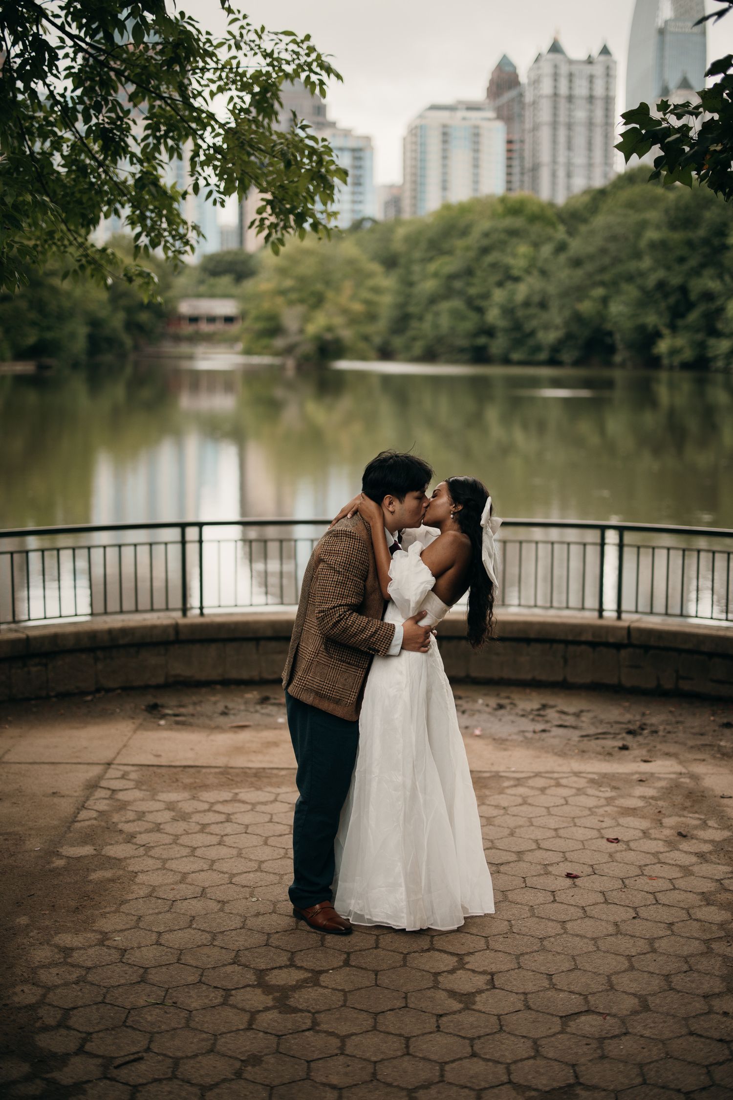 Piedmont Park elopement portrait with the Midtown Atlanta skyline in the background.