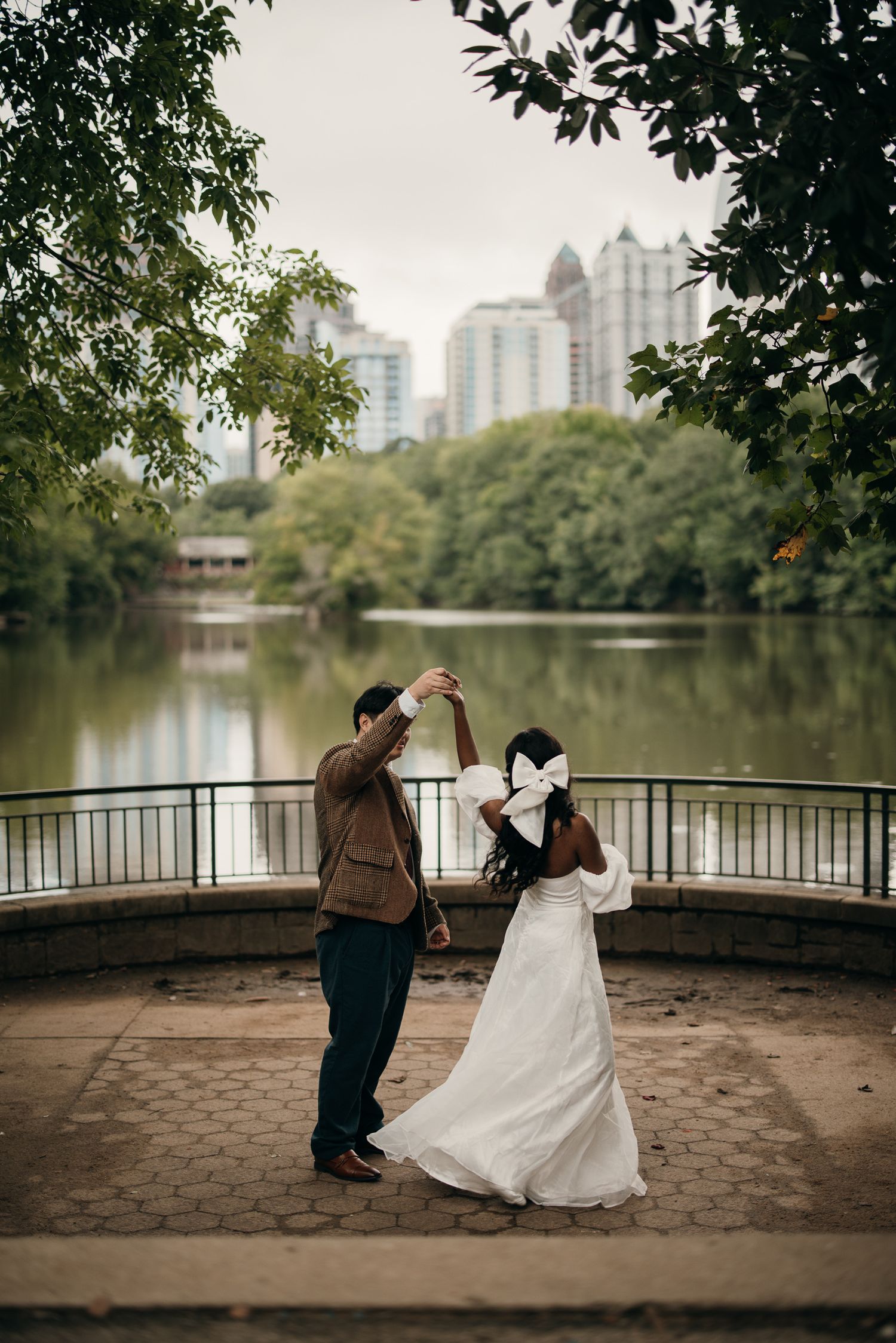 Piedmont Park elopement portrait with the Midtown Atlanta skyline in the background.
