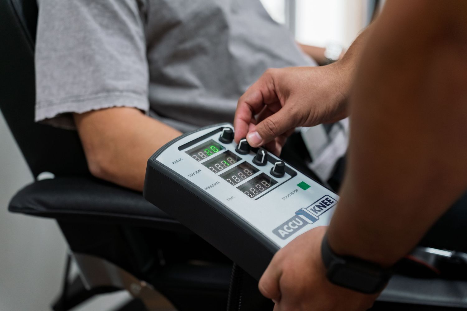 Someone enters information into a payment terminal keypad while sitting in a wheelchair.