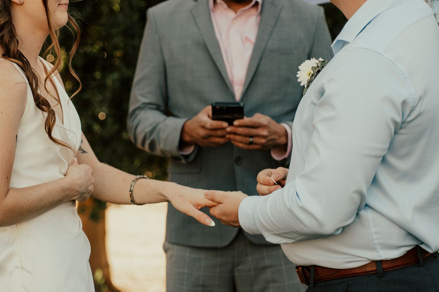 Candid moments between wedding party members during an outdoor celebration.