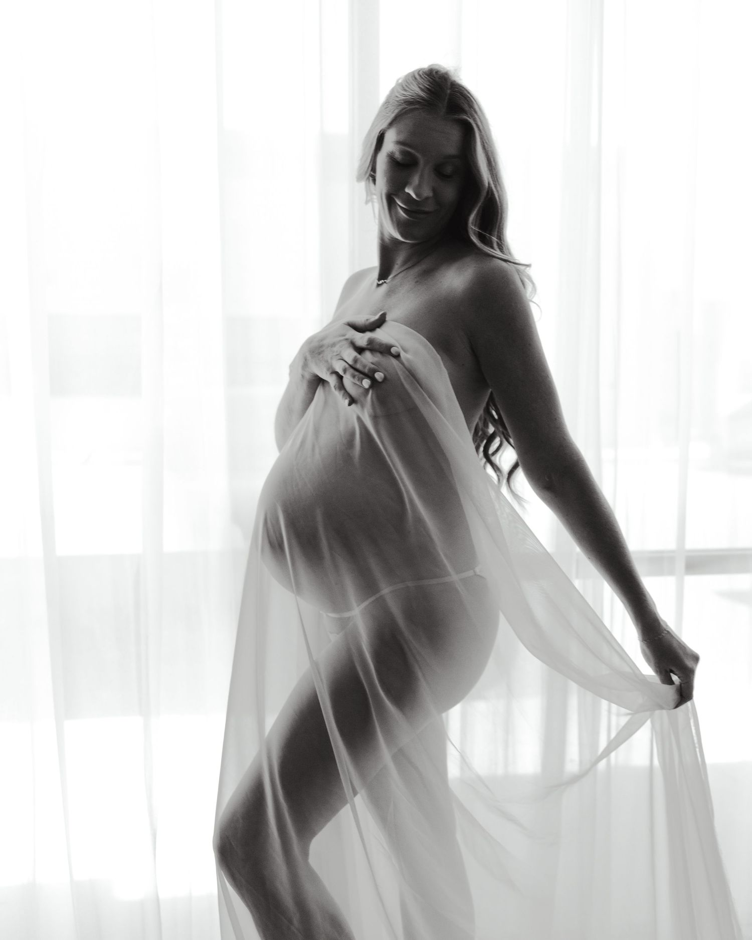 A series of artistic black and white boudoir photos showing a silhouette against bright window light.