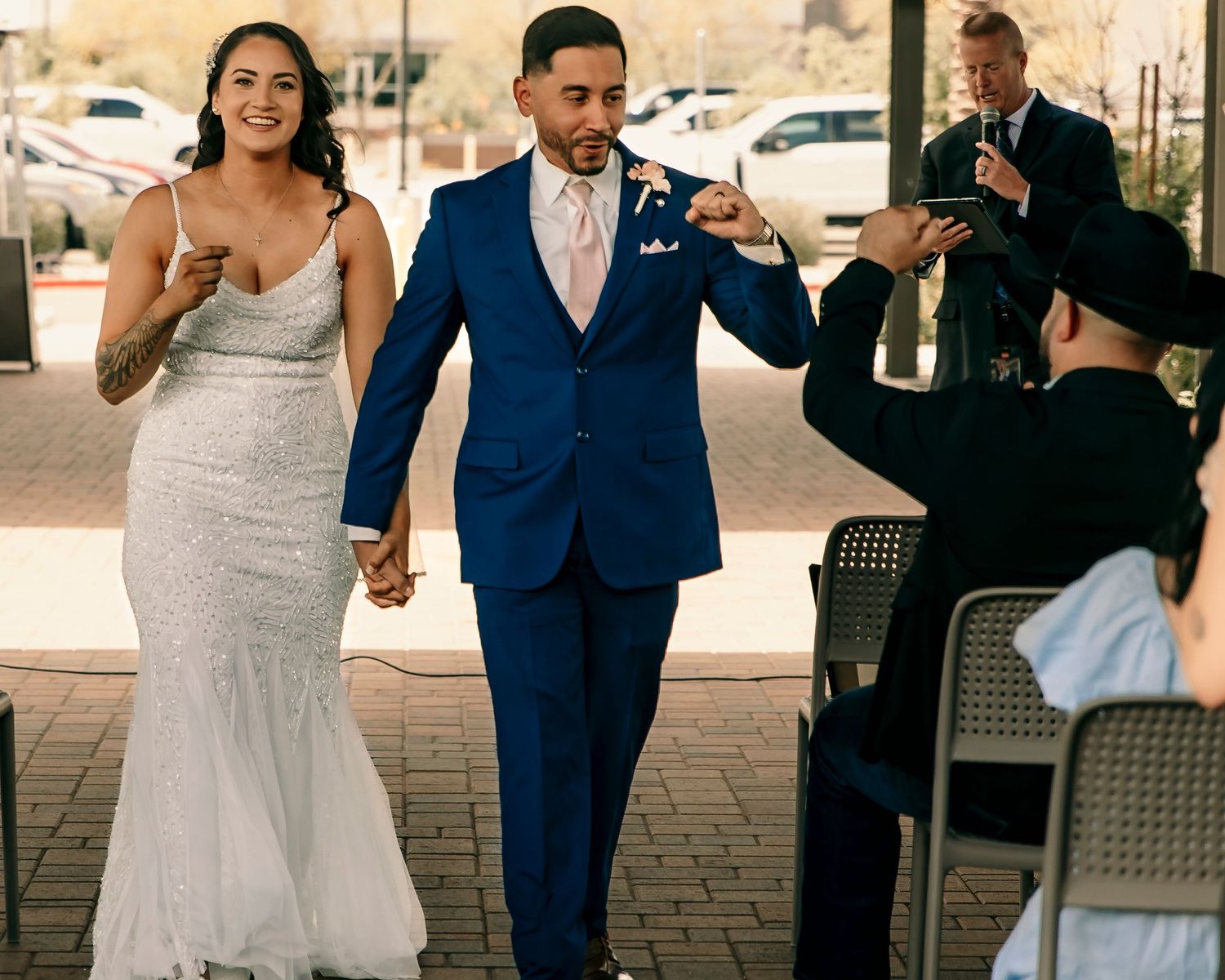 A celebratory moment as newlyweds walk together after their ceremony.