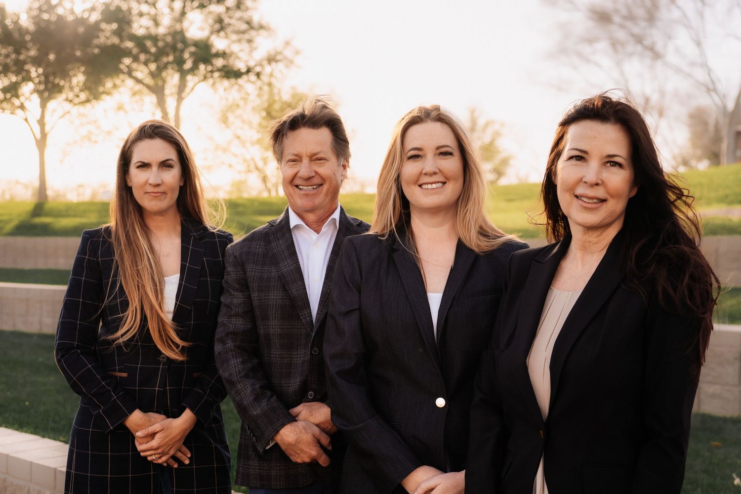 Professional business team in dark suits posed outdoors during sunset. Session in Anthem Arizona