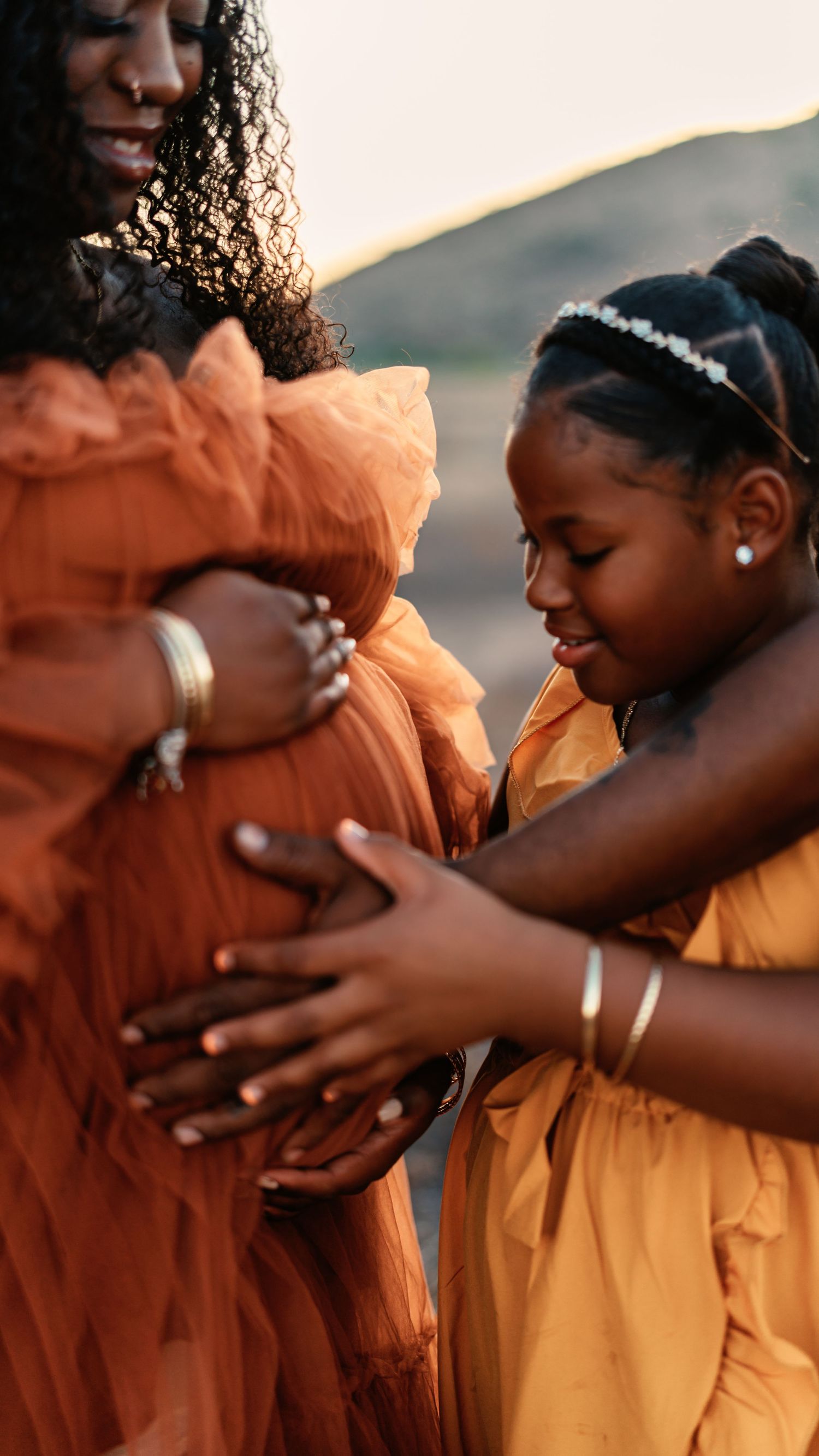 Artistic maternity portrait sequence showing emotional moments in coral dress outdoors.