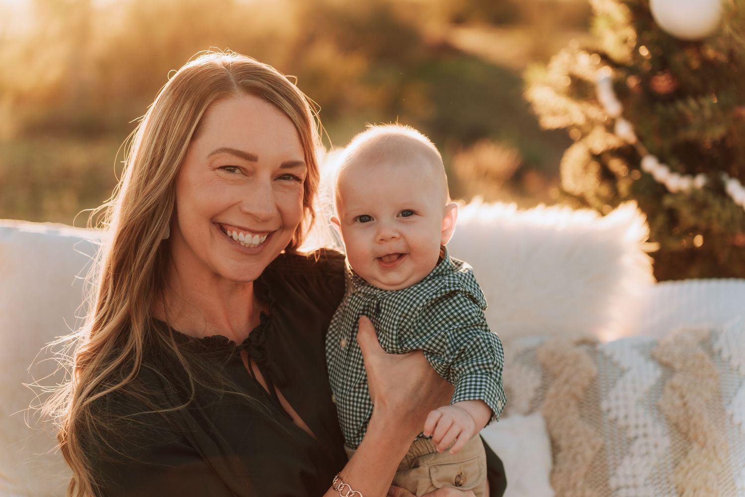 A parent and child share joyful moments together during a golden hour outdoor photoshoot.