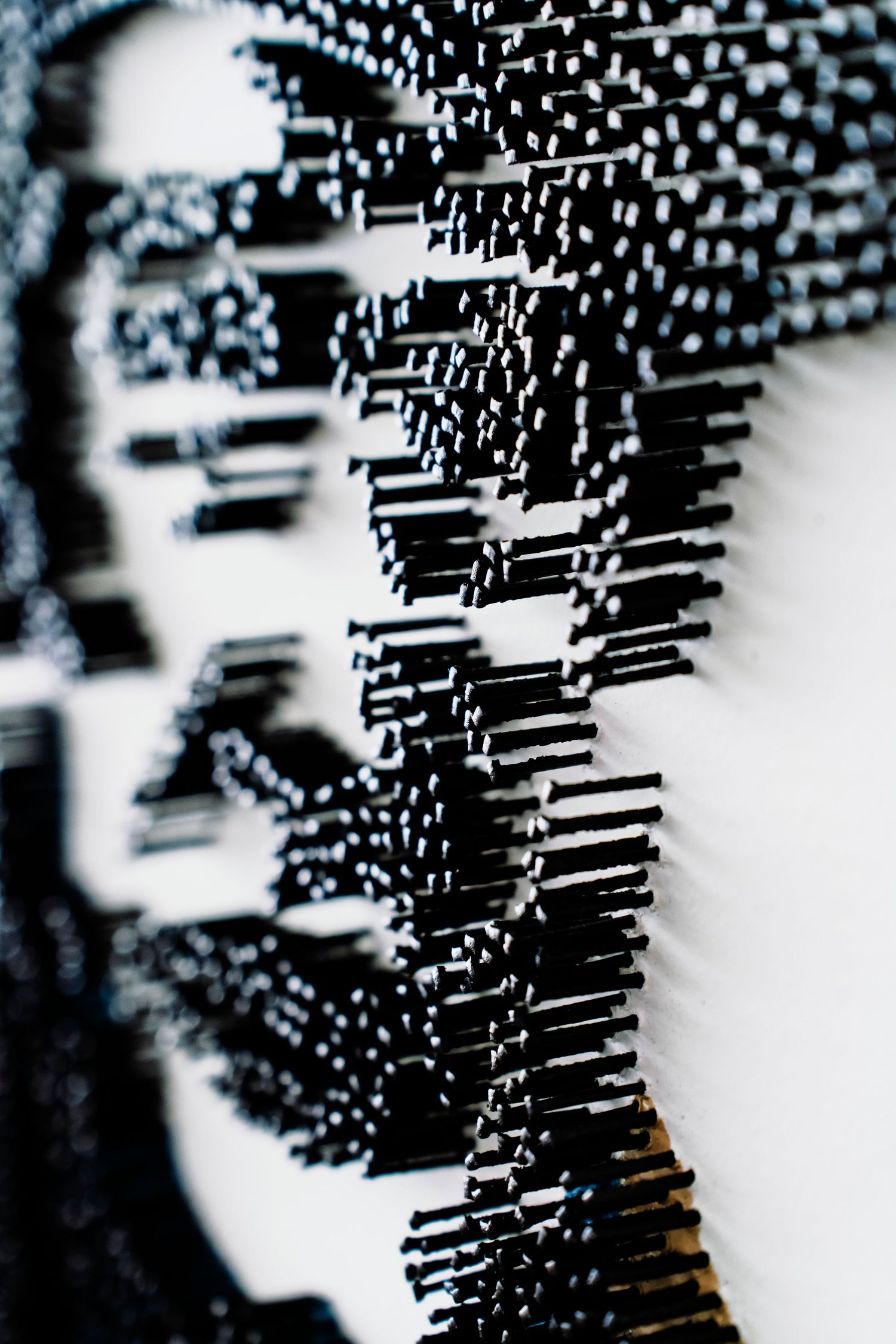 Abstract macro photograph of black metallic structures creating geometric patterns.