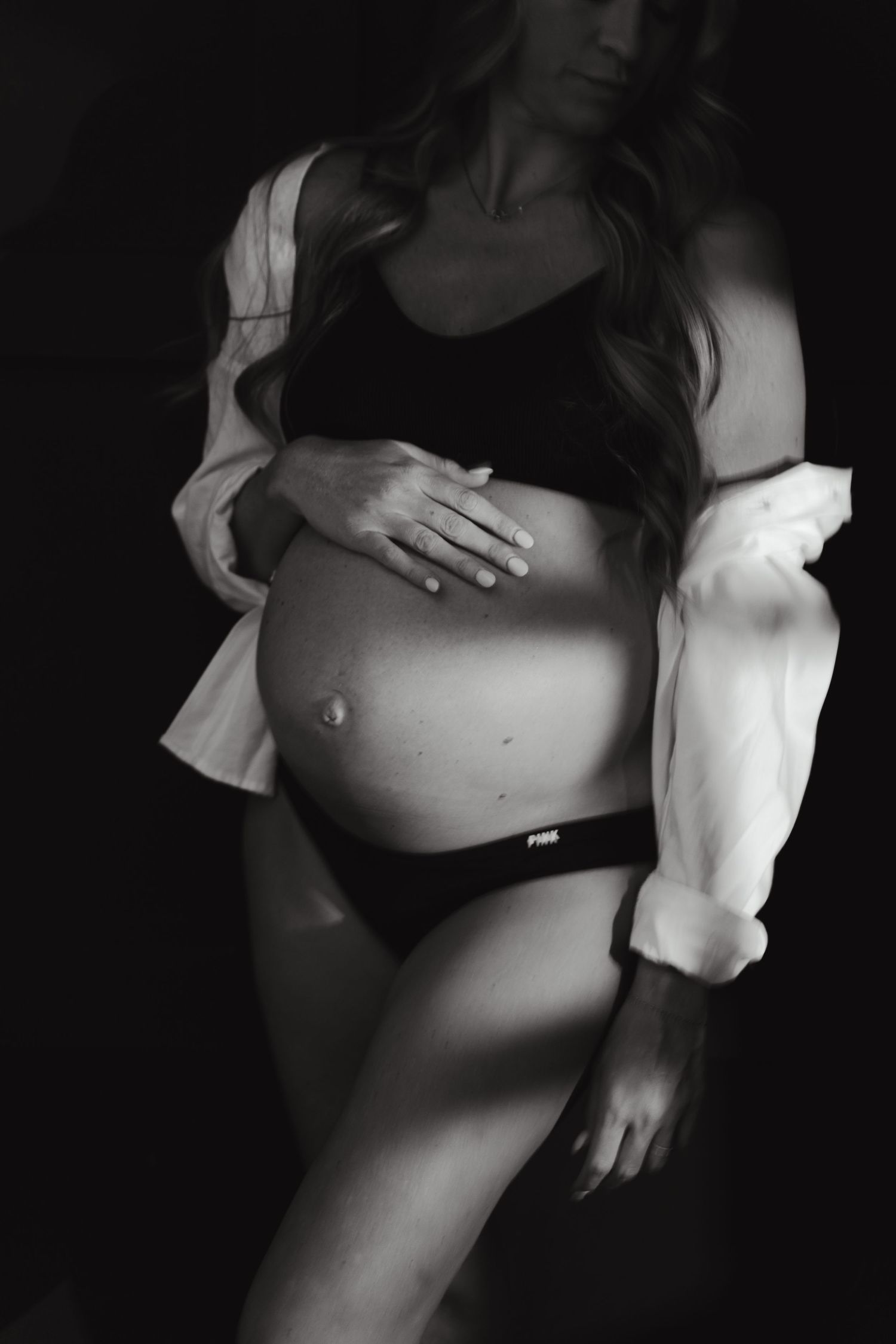 Artistic black and white portrait series showing close-up torso shots with dramatic shadows and lighting.