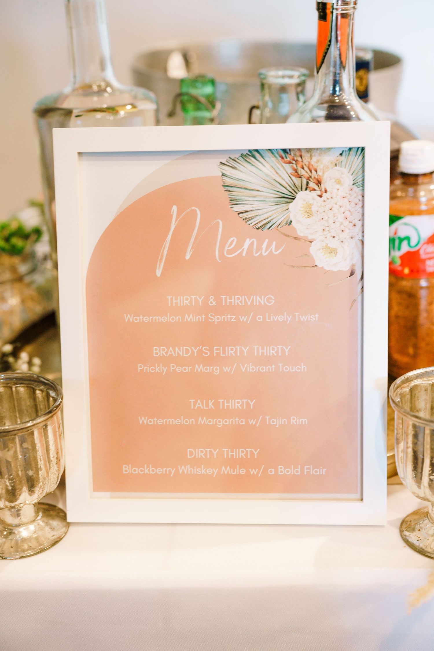 Tropical-themed menu card in peach color with palm leaf design displayed at event. Session in Phoenix Arizona