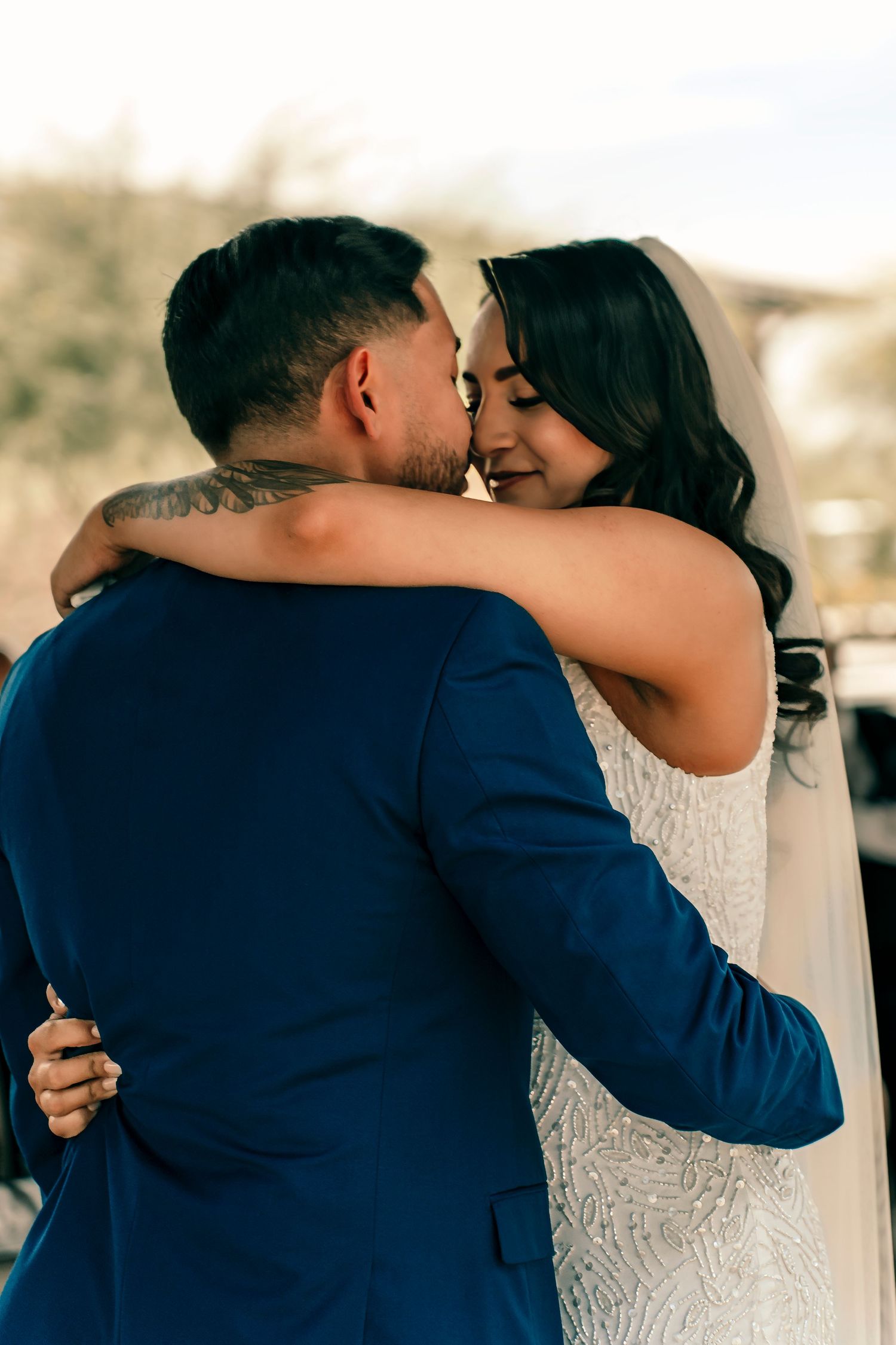 An intimate embrace between newlyweds during their wedding photoshoot.
