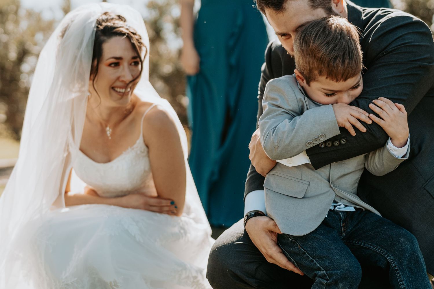 Intimate wedding moment at sunset with white lace dress and navy suit.