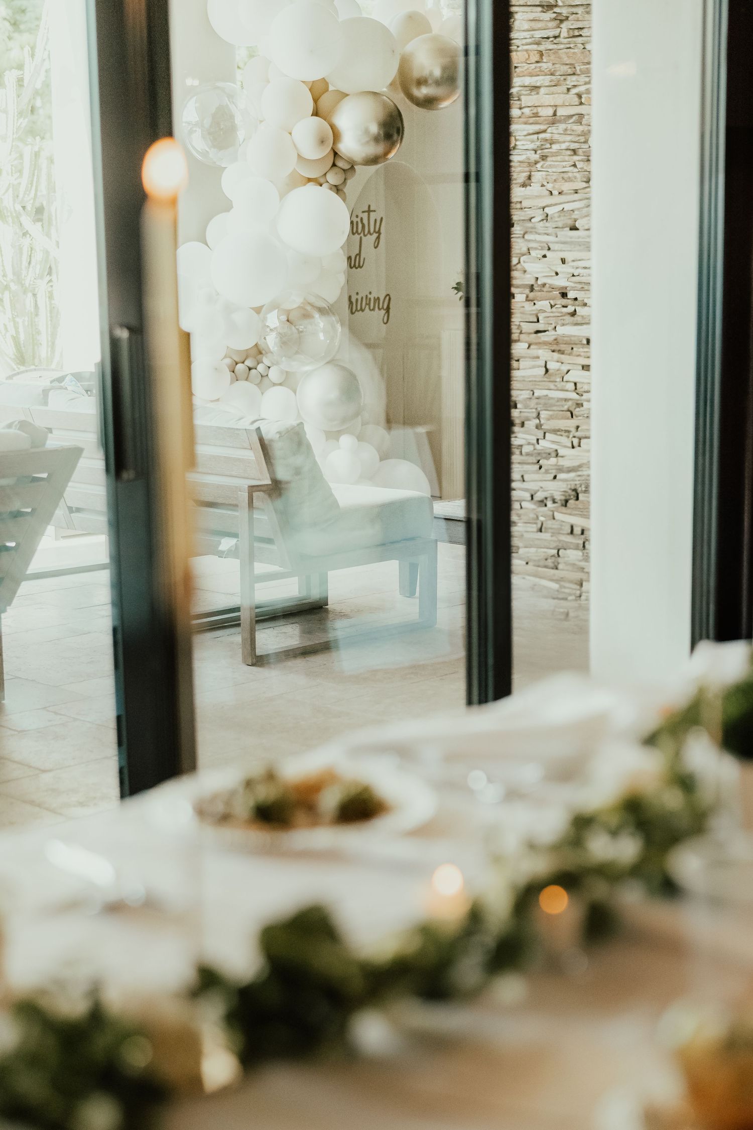 Modern event space with stone accent wall and white balloon decorations. Session in Phoenix Arizona