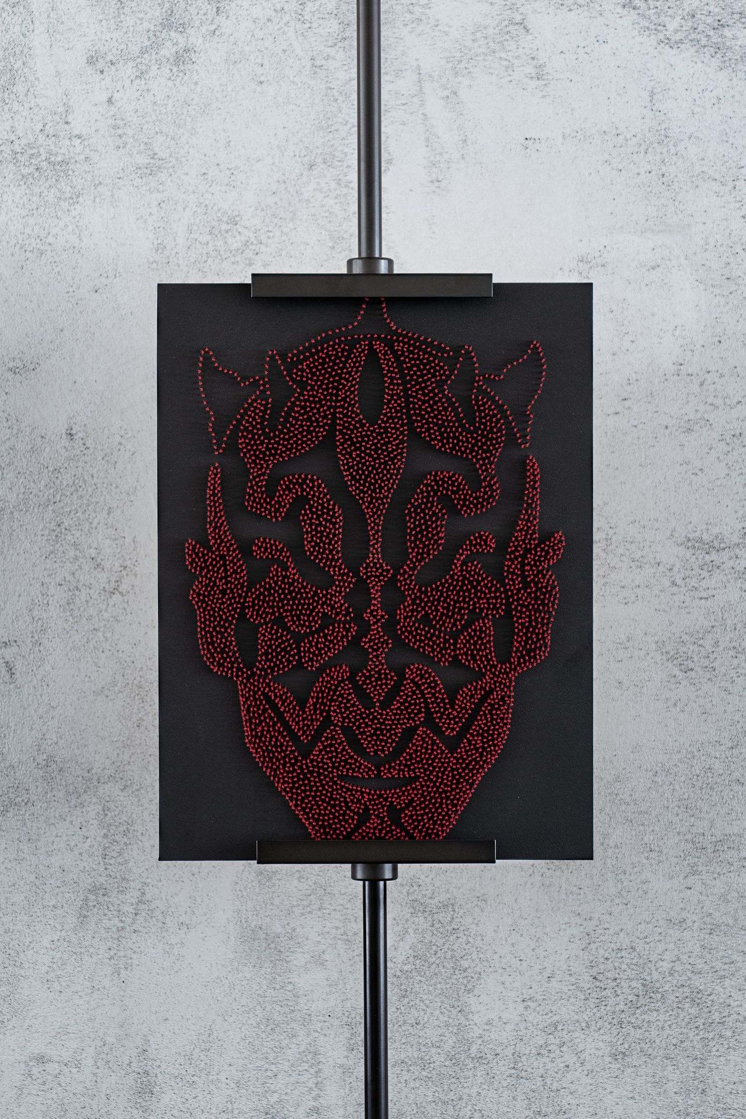 A sequence of red LED art pieces mounted on black panels showing an abstract geometric pattern evolution.