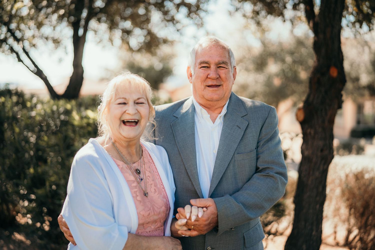Senior couple sharing joyful moment outdoors in natural lighting.