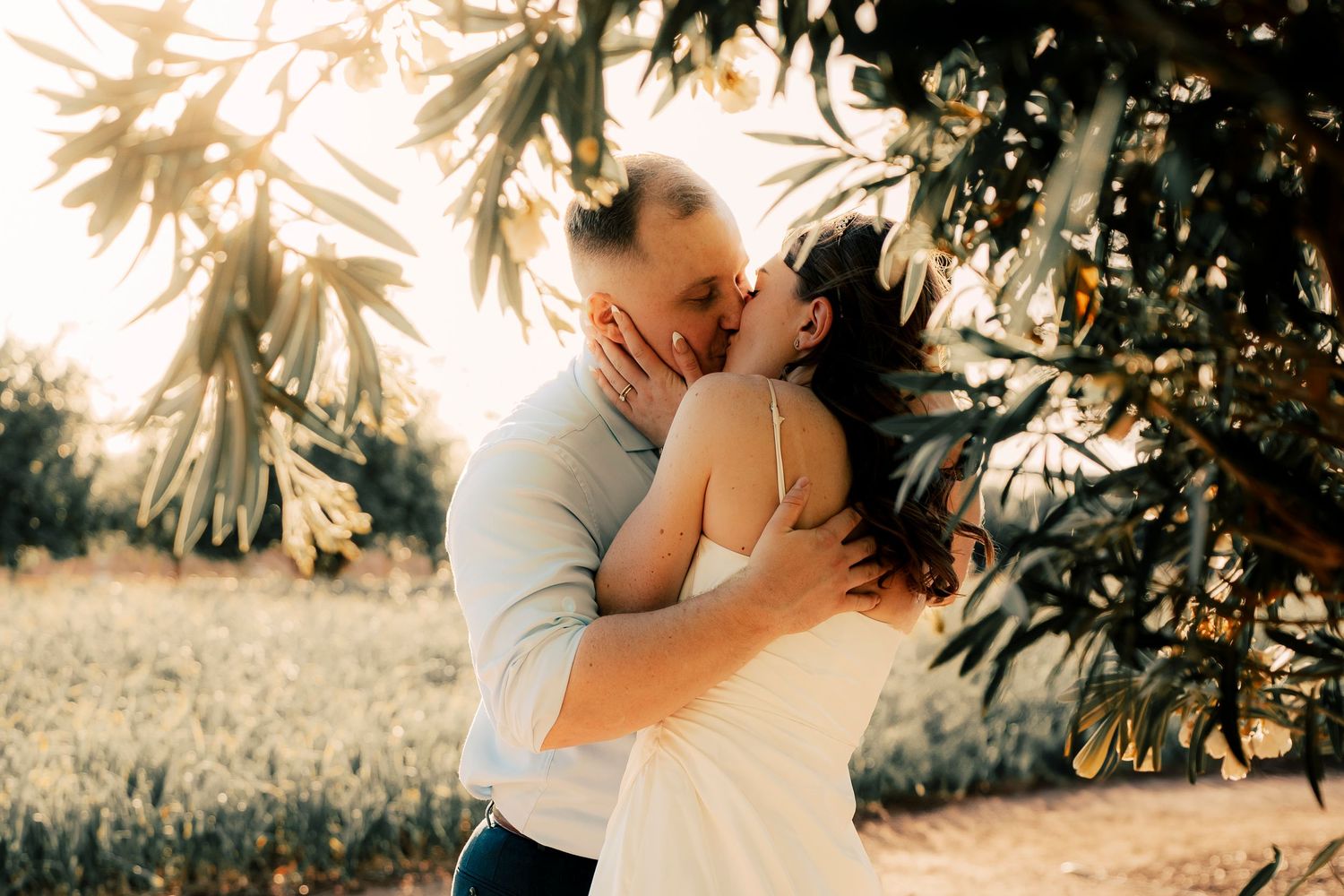 A romantic sunset wedding shoot showing a couple sharing tender moments in natural lighting.